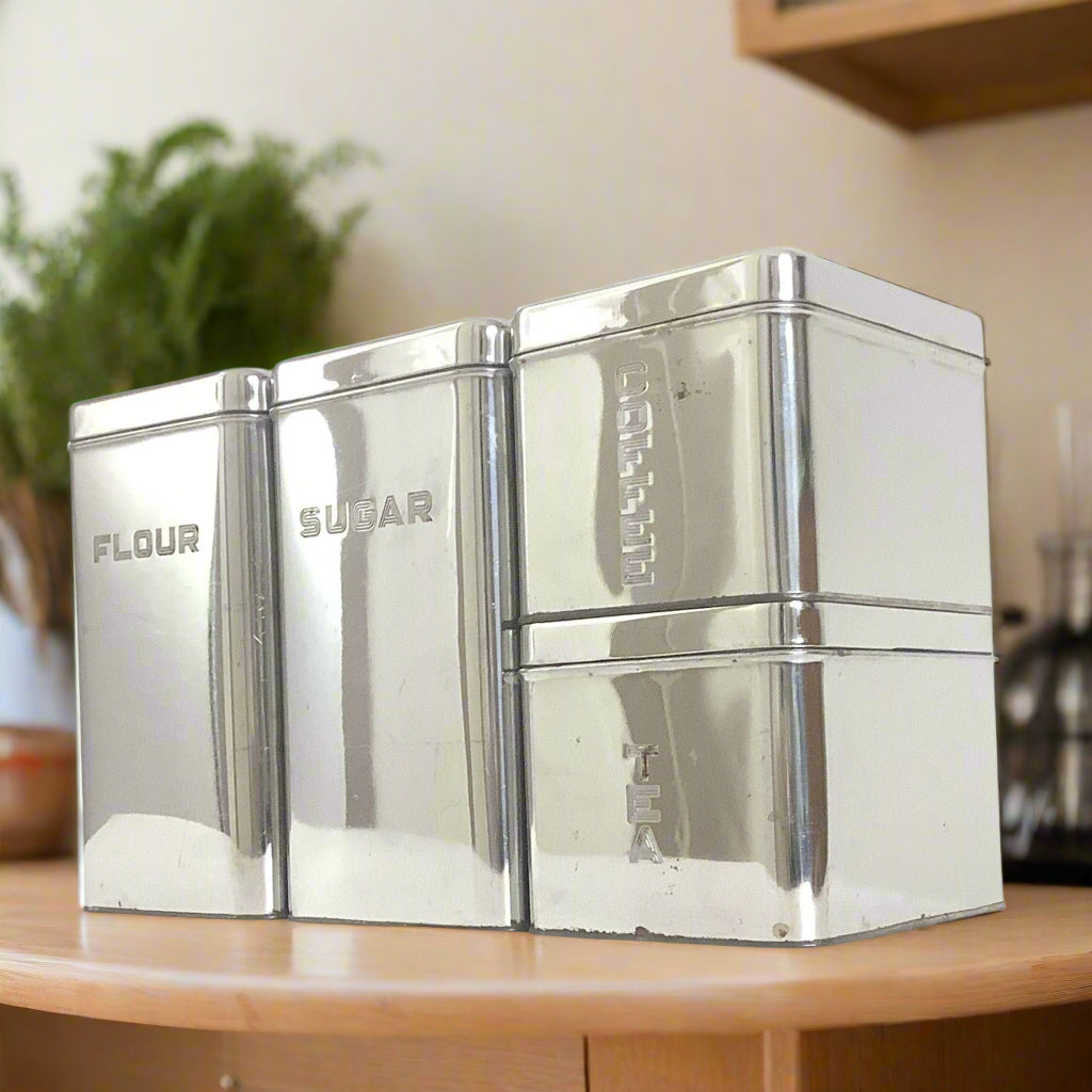 Chrome Kitchen Canisters on wood counter greenery olive oil in background