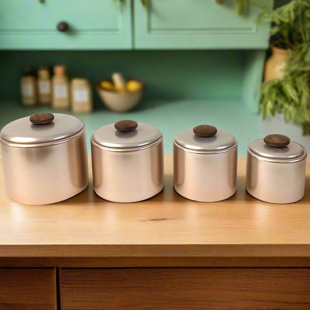 Metallic Pink Kitchen Canisters on wood table and green cabinet in background