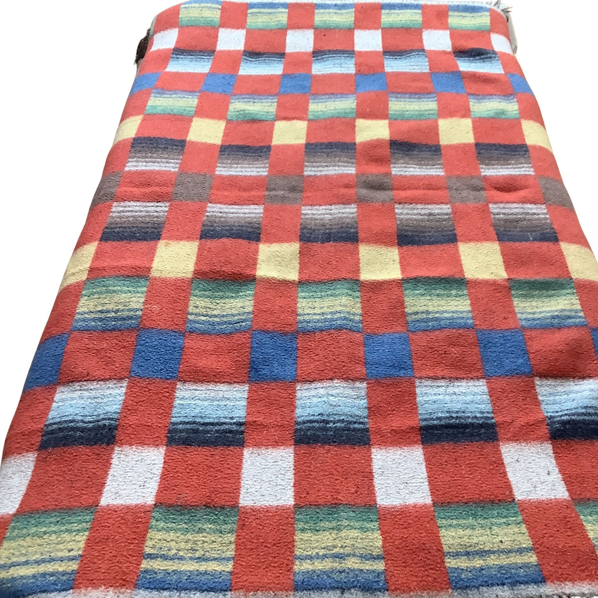 Top view of a vintage 1940s woven wool blanket in a colorful checkered pattern, featuring alternating blocks of red, blue, green, yellow, and white stripes, shown against a plain white background.