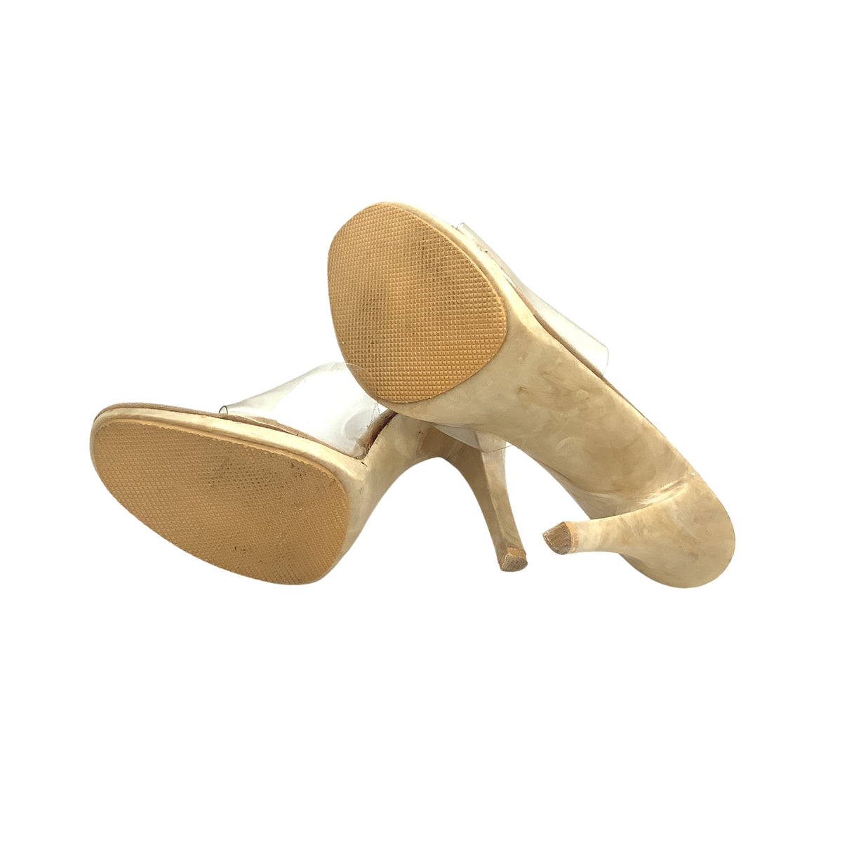 A pair of women's vintage Delmar brand high-heeled pumps shown from the sole and side view, featuring a clear upper and a beige textured sole grips.