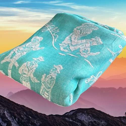 teal blue folded blanket with cowboy graphics mountain background 