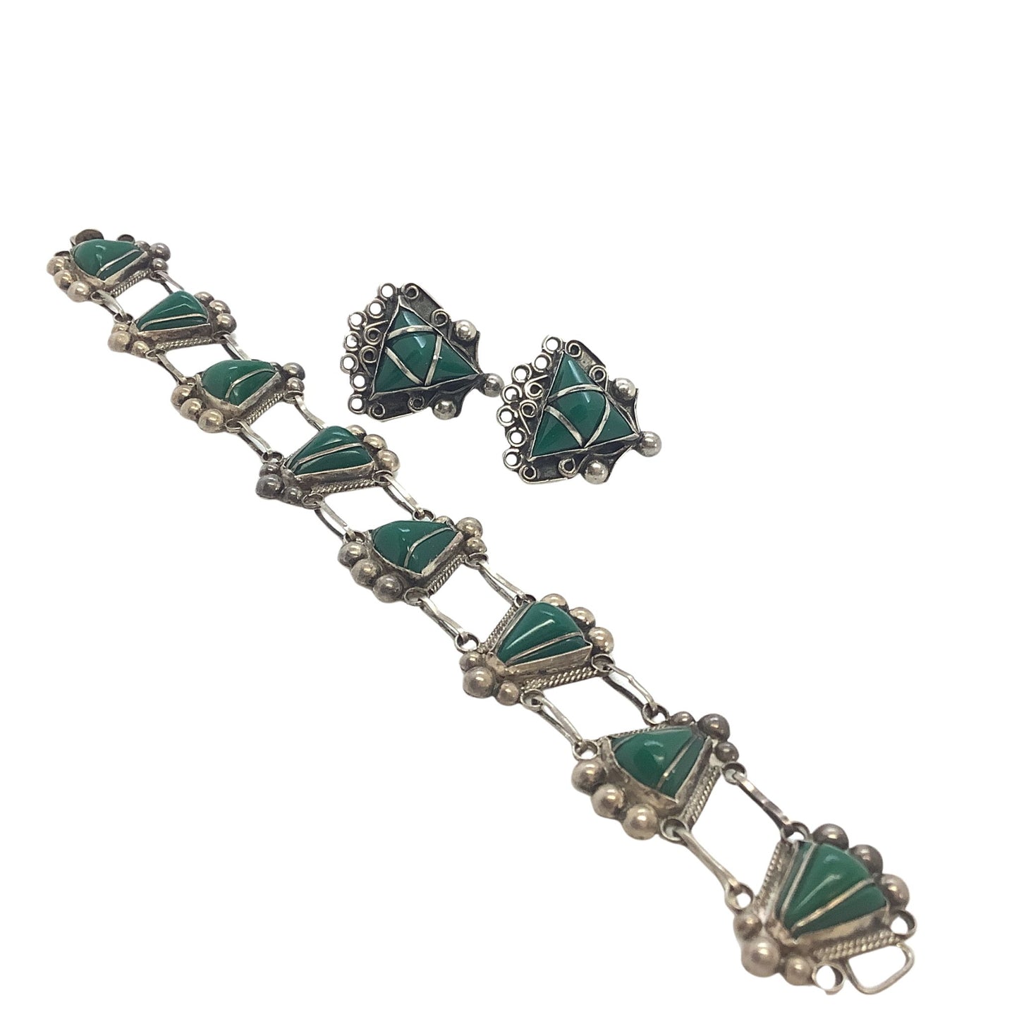 1930s Mexican sterling jewelry set on a white background
