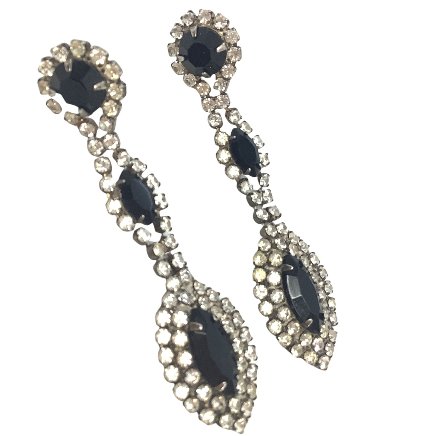 Pair of earrings with dark gemstones and clear stones on a white background