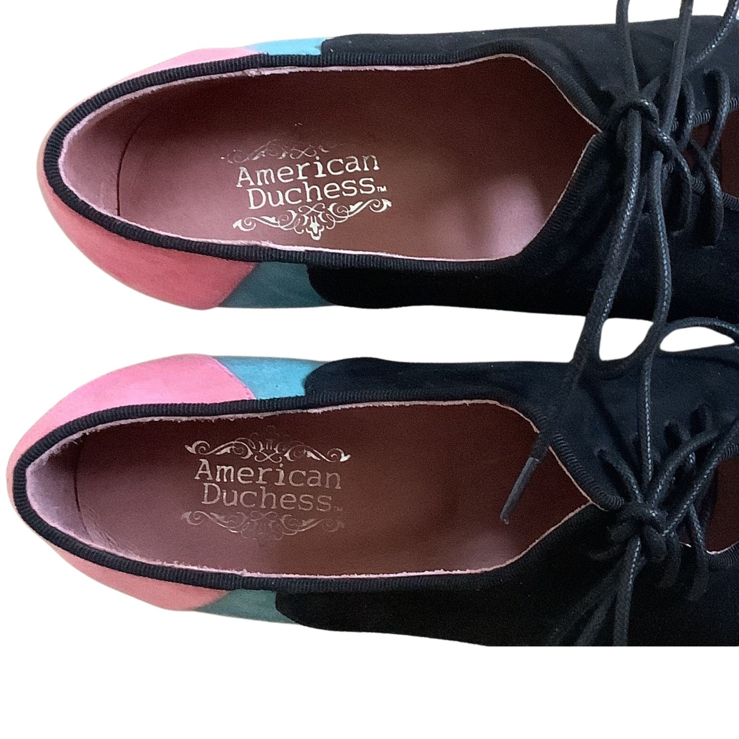 American Duchess multicolor heels detail view showing color-block pattern with black pink teal on white background