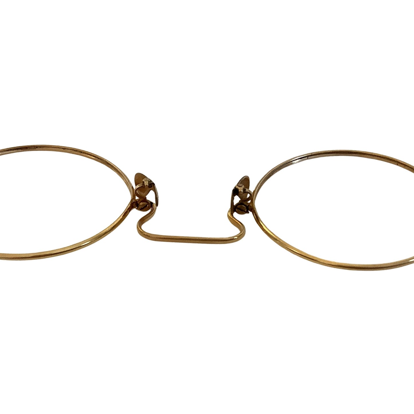 Pair of gold-rimmed eyeglasses close-up