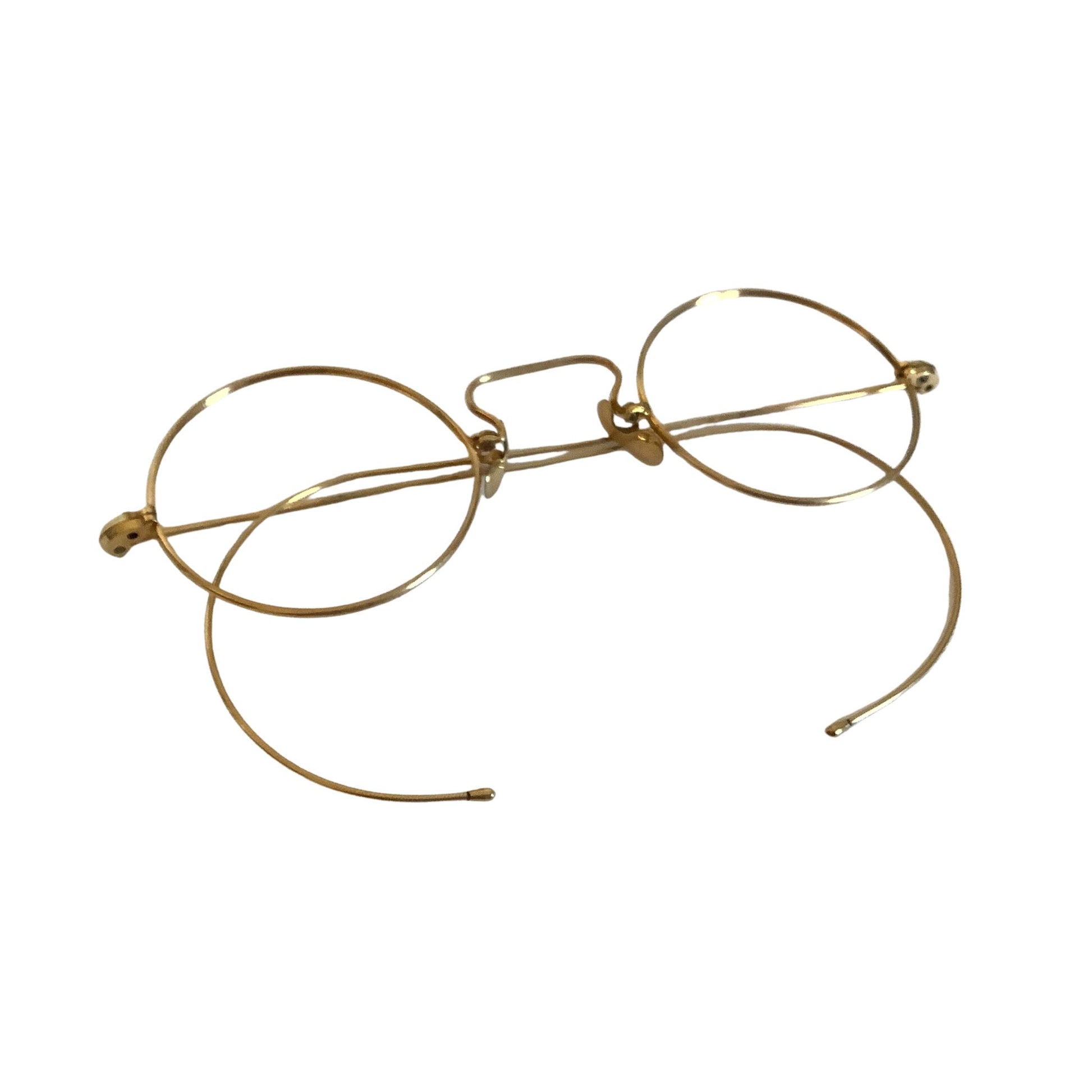 Gold-rimmed eyeglasses folded