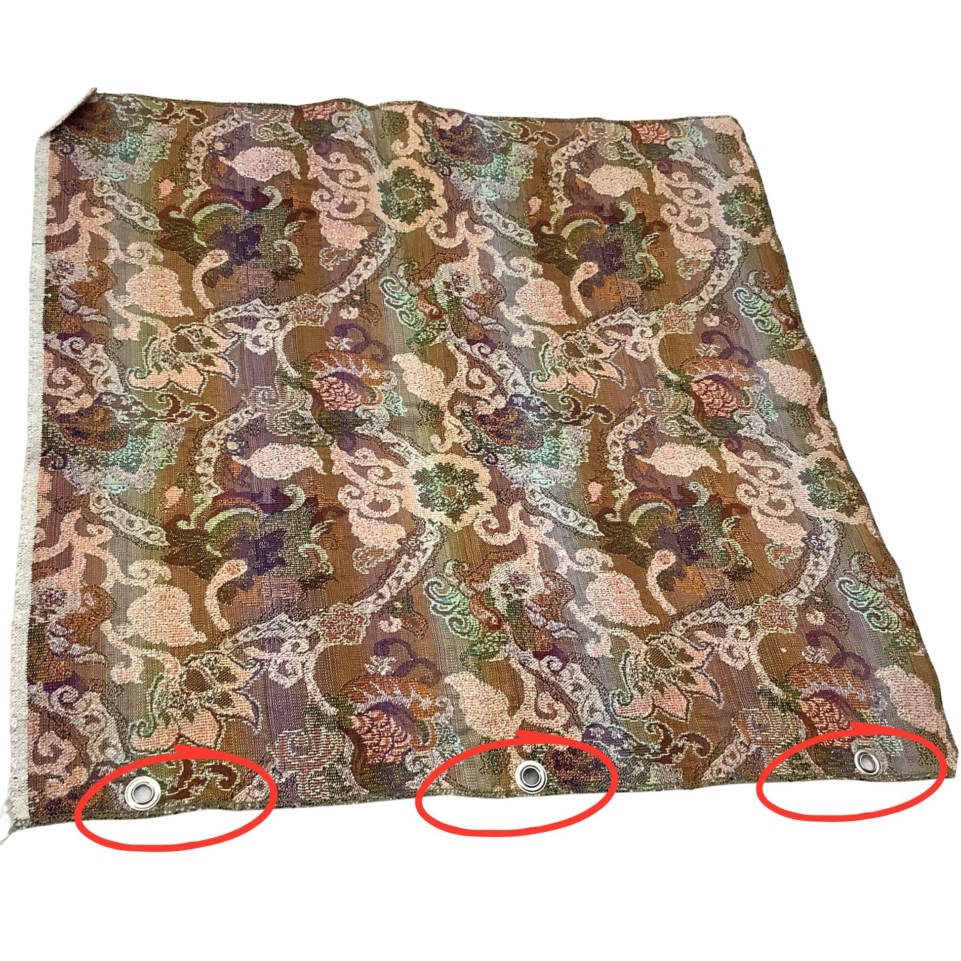 Vintage fabric sample with an ornate repeating brocade-style pattern in brown, beige, green, and purple tones, shown flat on a white background. Three metal grommets are visible along the bottom edge, with red circles highlighting them.