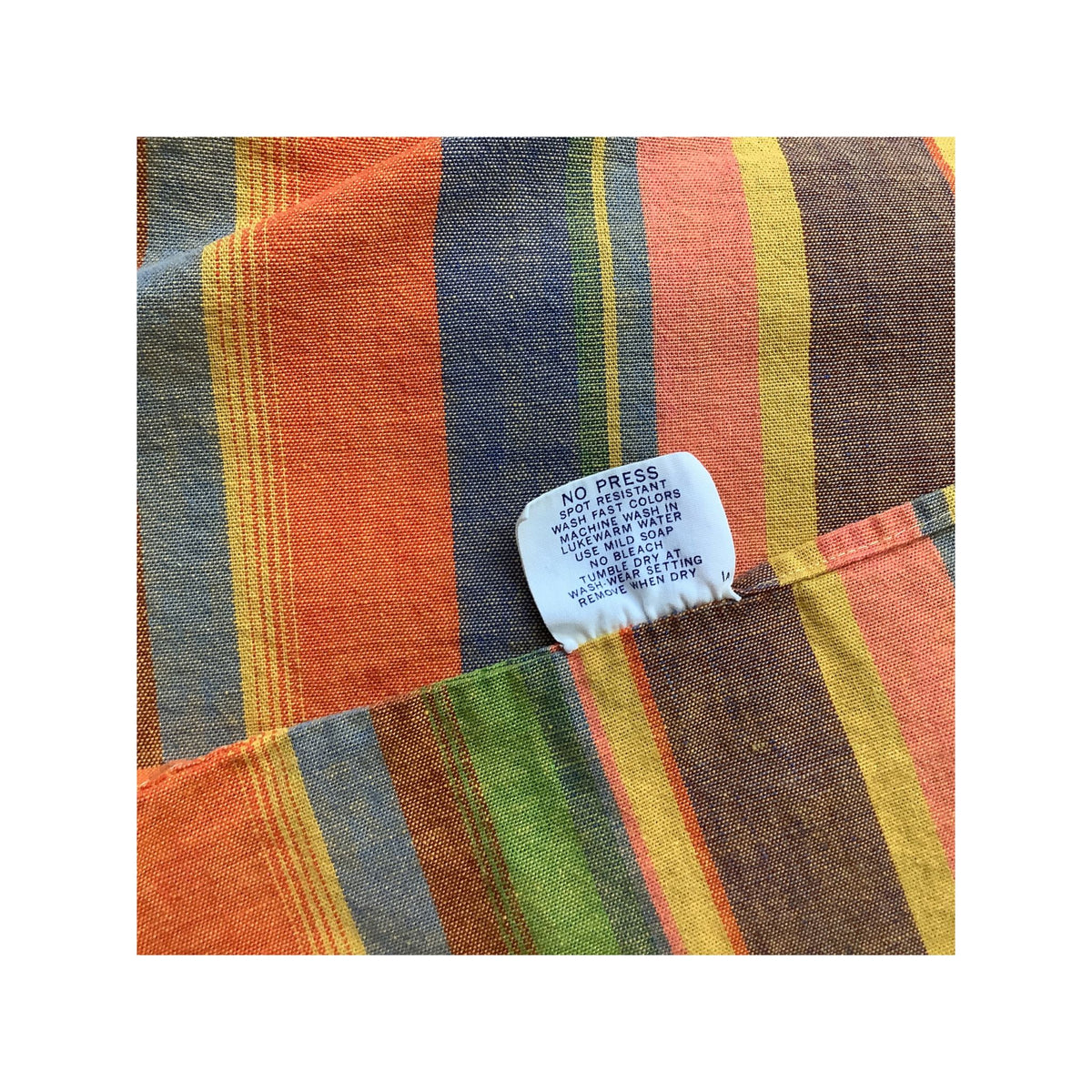 Bates striped bedspread featuring a close-up of a care label.