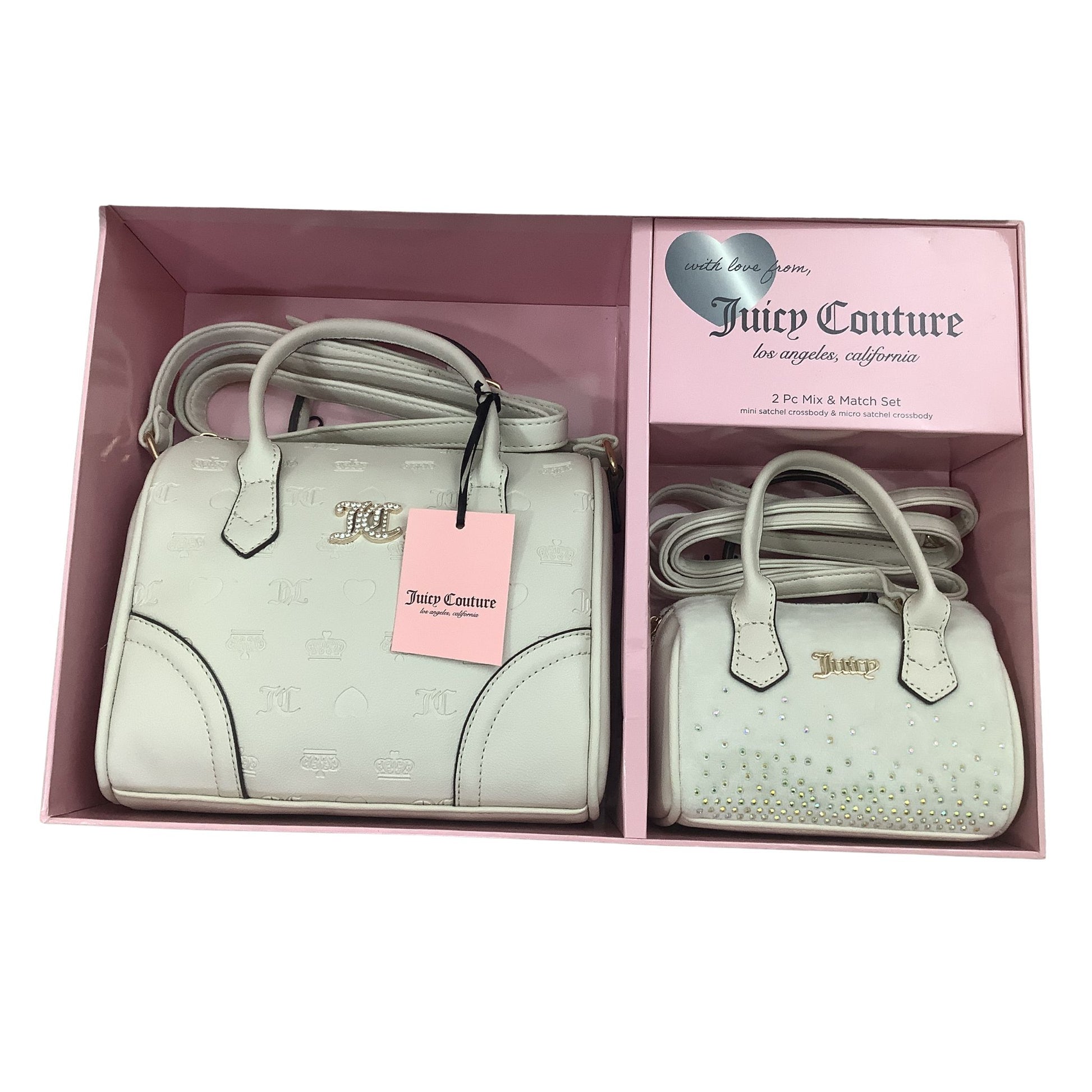 Juicy Couture handbag set in a box with pink interior on a white background