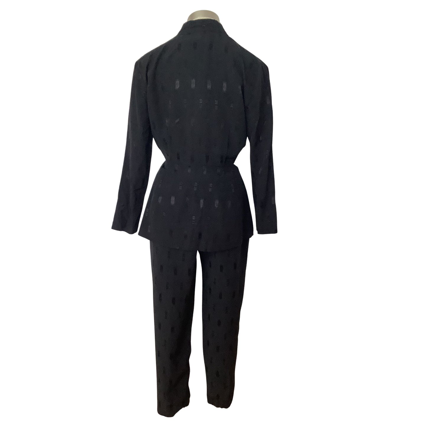 A black two-piece suit with a subtle geometric tone-on-tone pattern