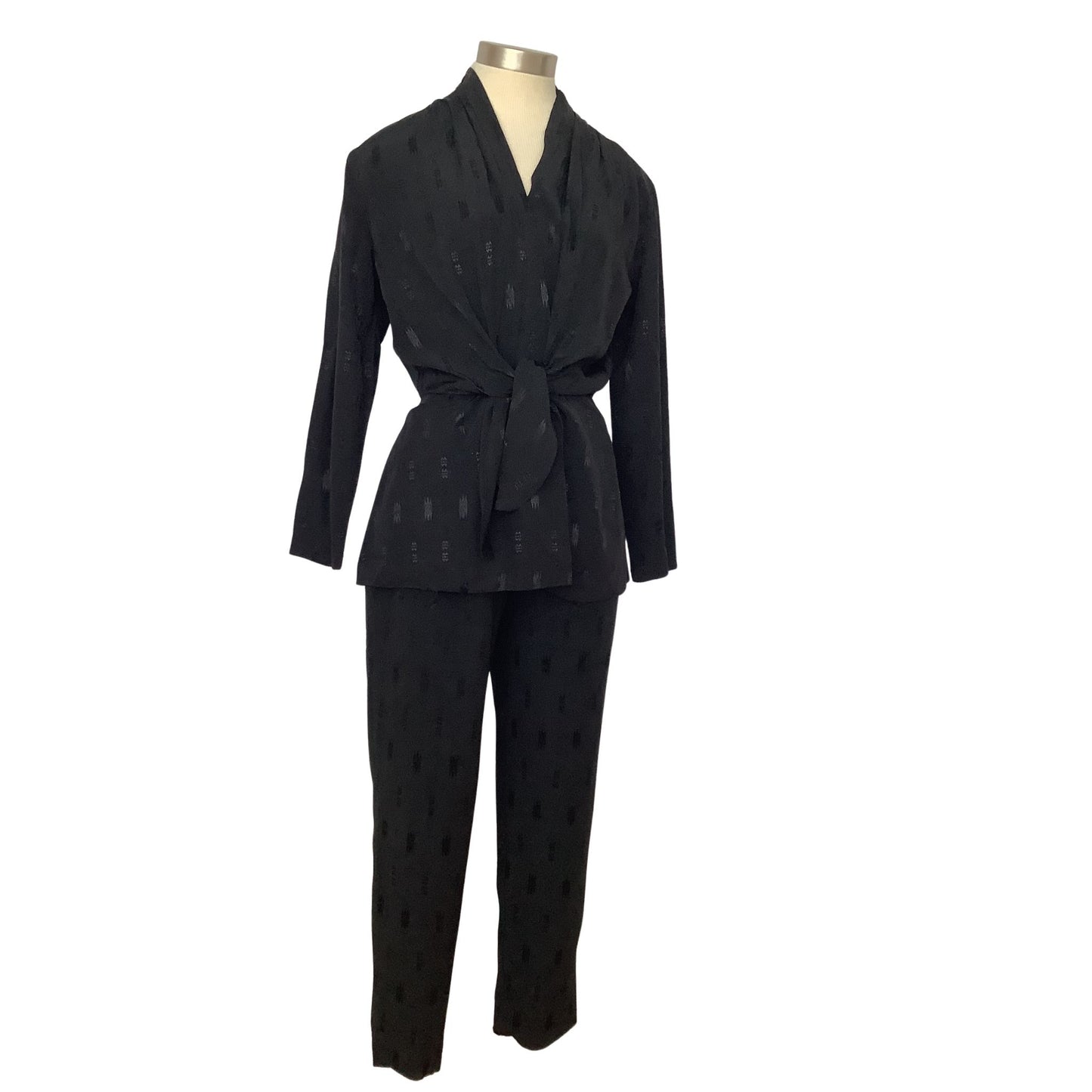 A black two-piece matching set consisting of a long-sleeve belted wrap jacket and matching trousers.