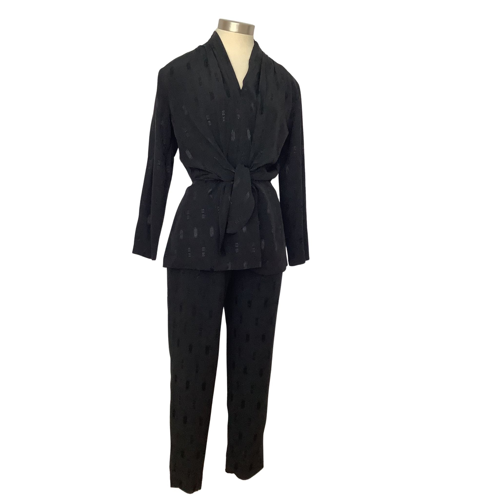 A black two-piece matching set consisting of a long-sleeve belted wrap jacket and matching trousers.
