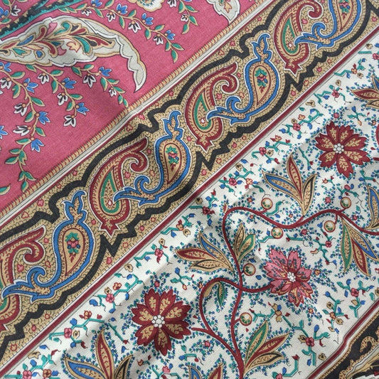 Close-up of a colorful paisley patterned fabric with intricate designs.