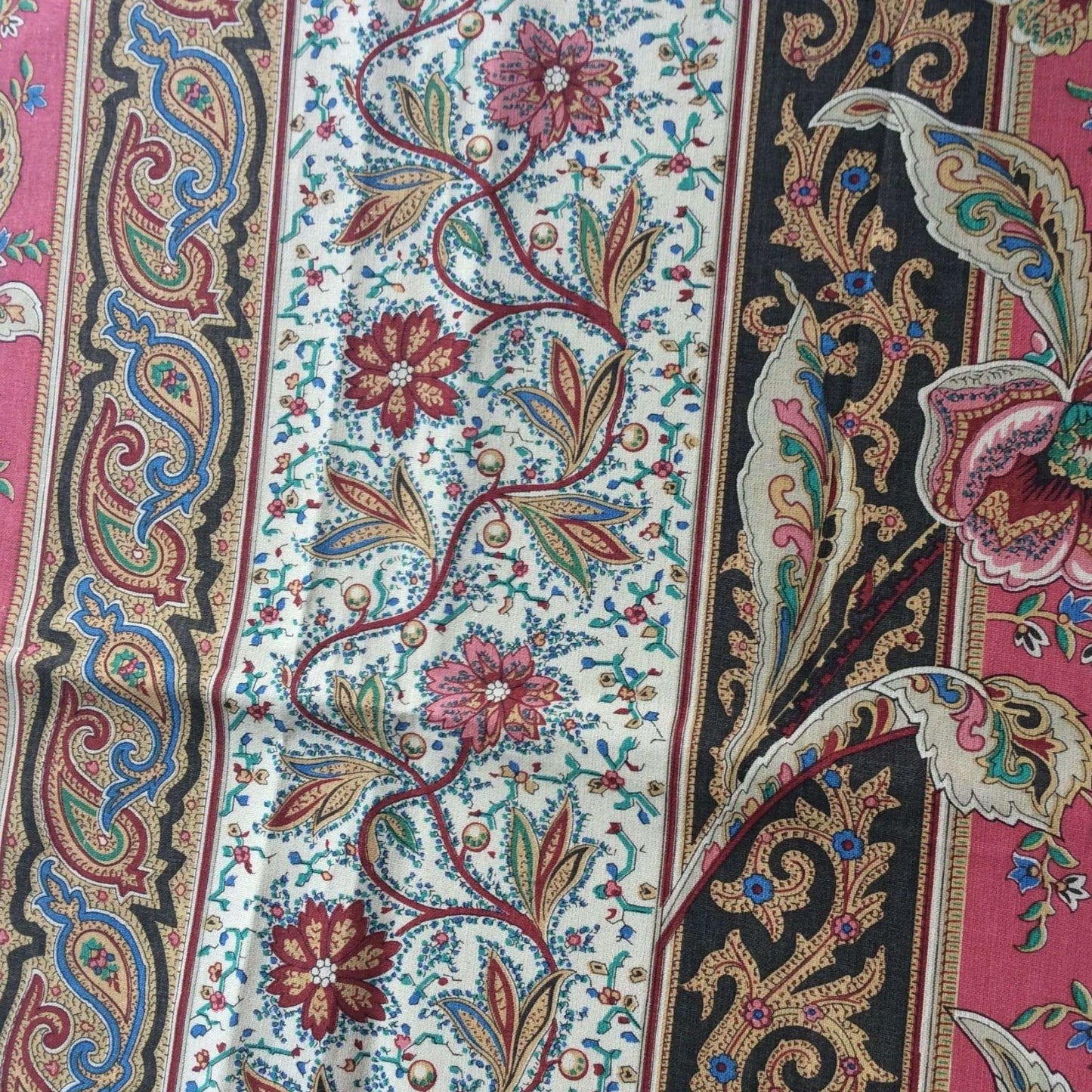 Side view of a colorful paisley patterned fabric with intricate designs.