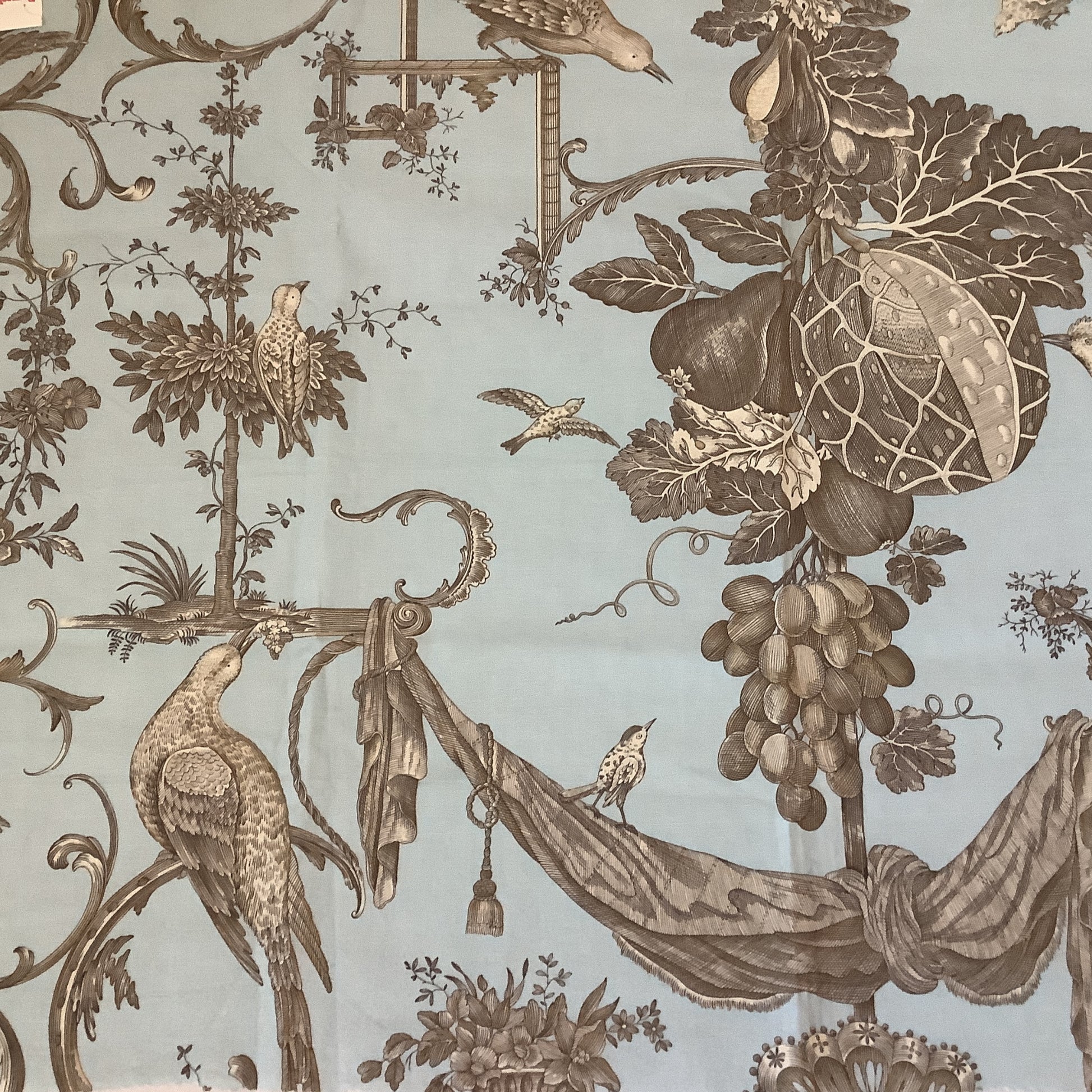 Brunschwig & Fils Kininvie baroque toile cotton fabric sample, blue ground with brown birds, botanicals, and scrollwork.

