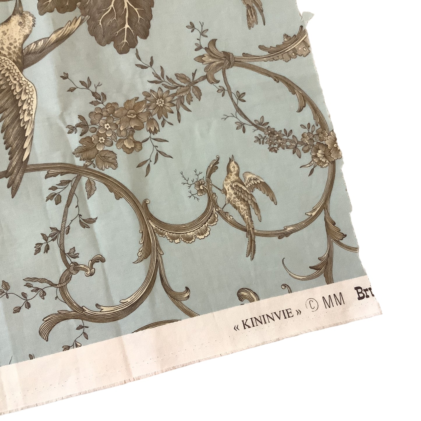 Brunschwig & Fils Kininvie fabric sample selvage label detail, blue toile with birds and floral scrollwork.
