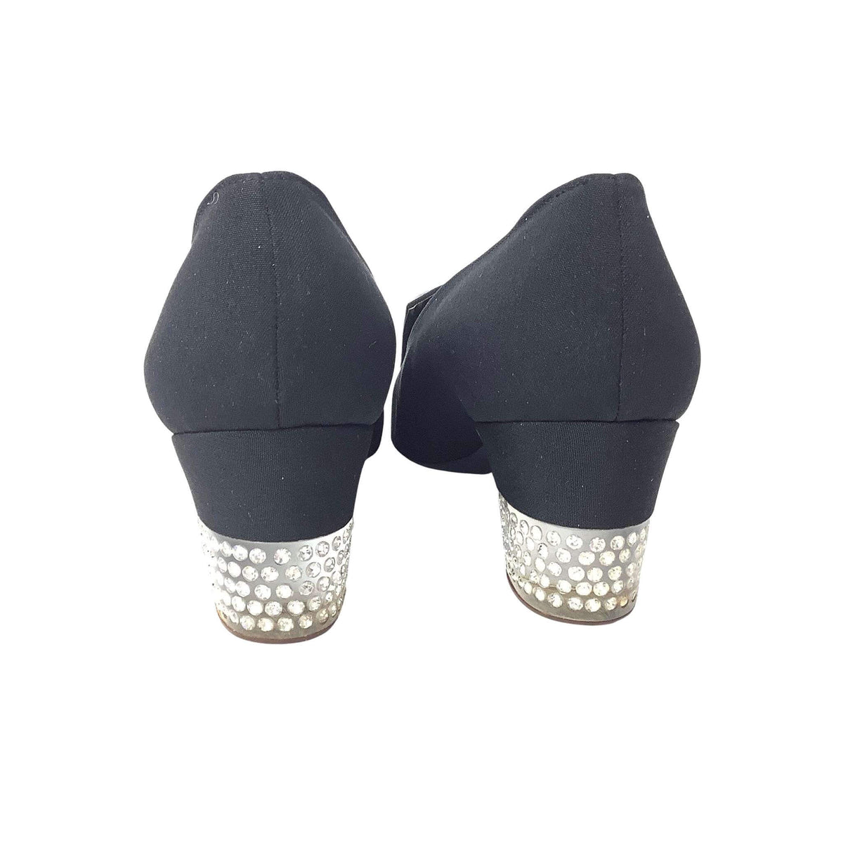 Black high-heeled shoes with pearl and crystal embellishments on a white background