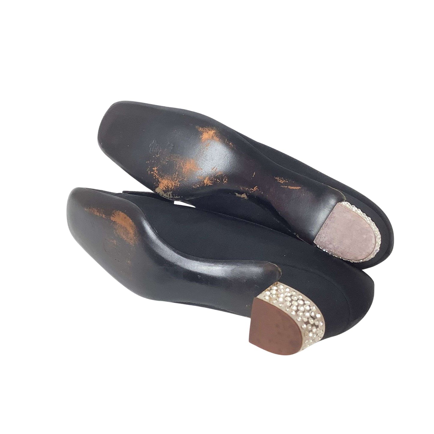 Pair of black high-heeled shoes with decorative sole view