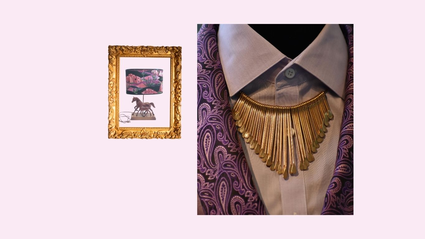 Mannequin wearing a decorative gold necklace with a framed artwork in the corner.