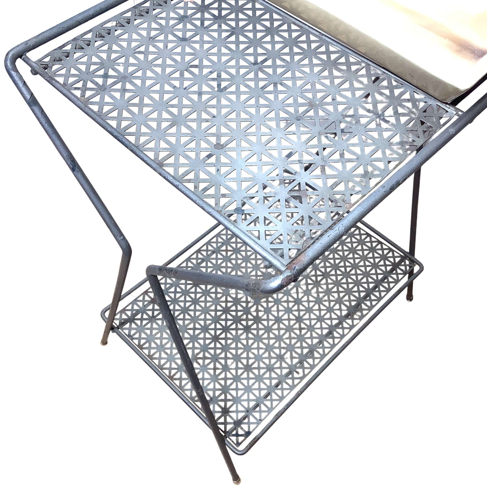 Close-up view of Metallic geometric-patterned table on a white background