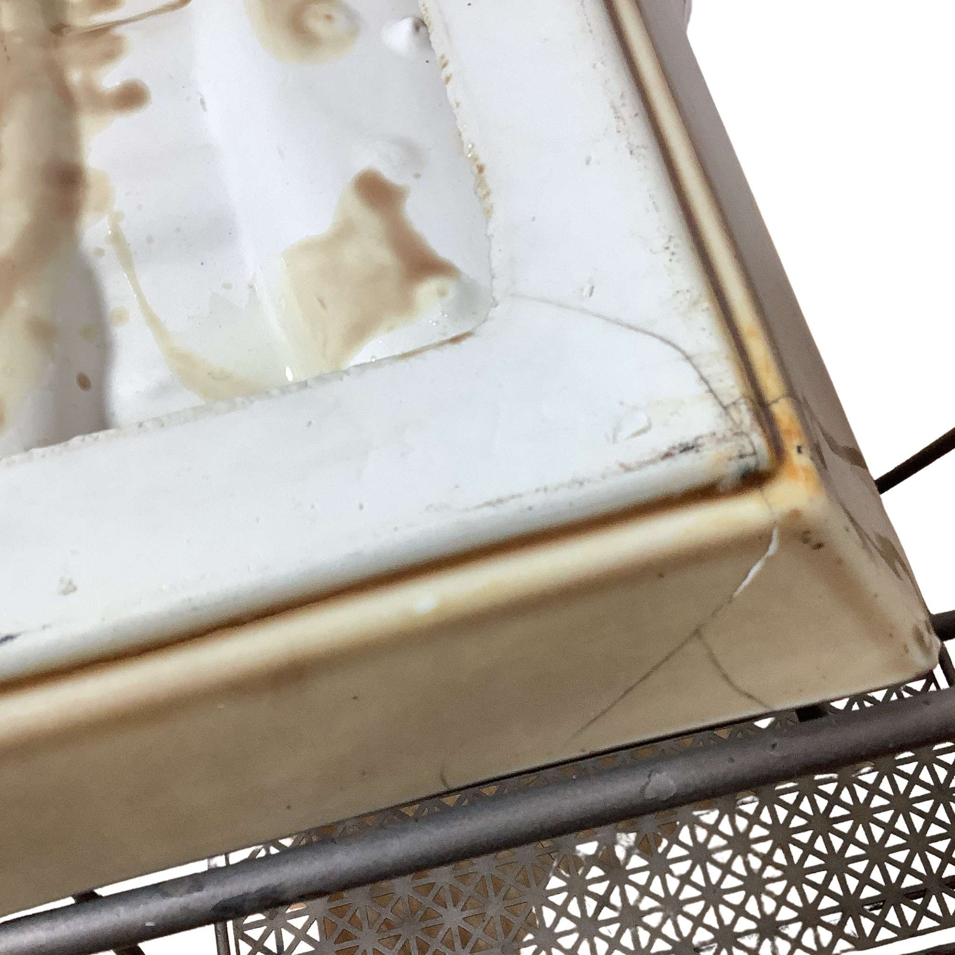 Close-up view of ceramic ashtray and metal frame on a white background