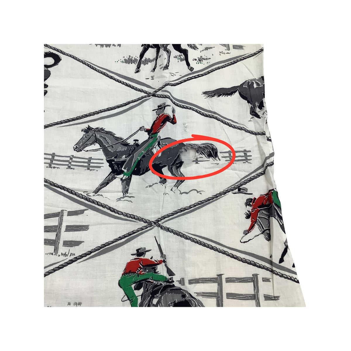 Vintage cowboy fabric in white cotton featuring a rustic western print of black horses, riders in red and green, and gray rope details. Red circle around hole