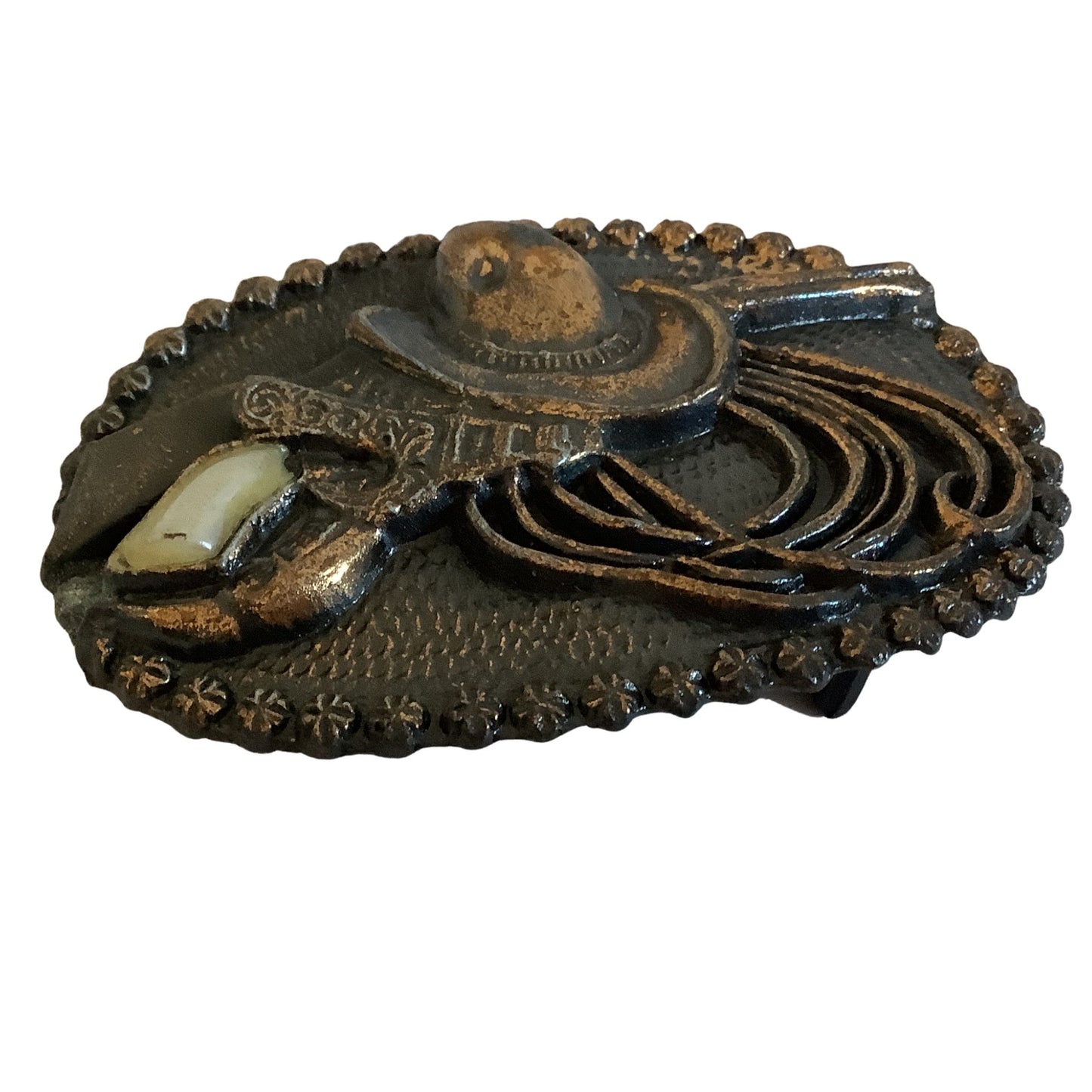 Side view of bronze cowgirl belt buckle on a white background