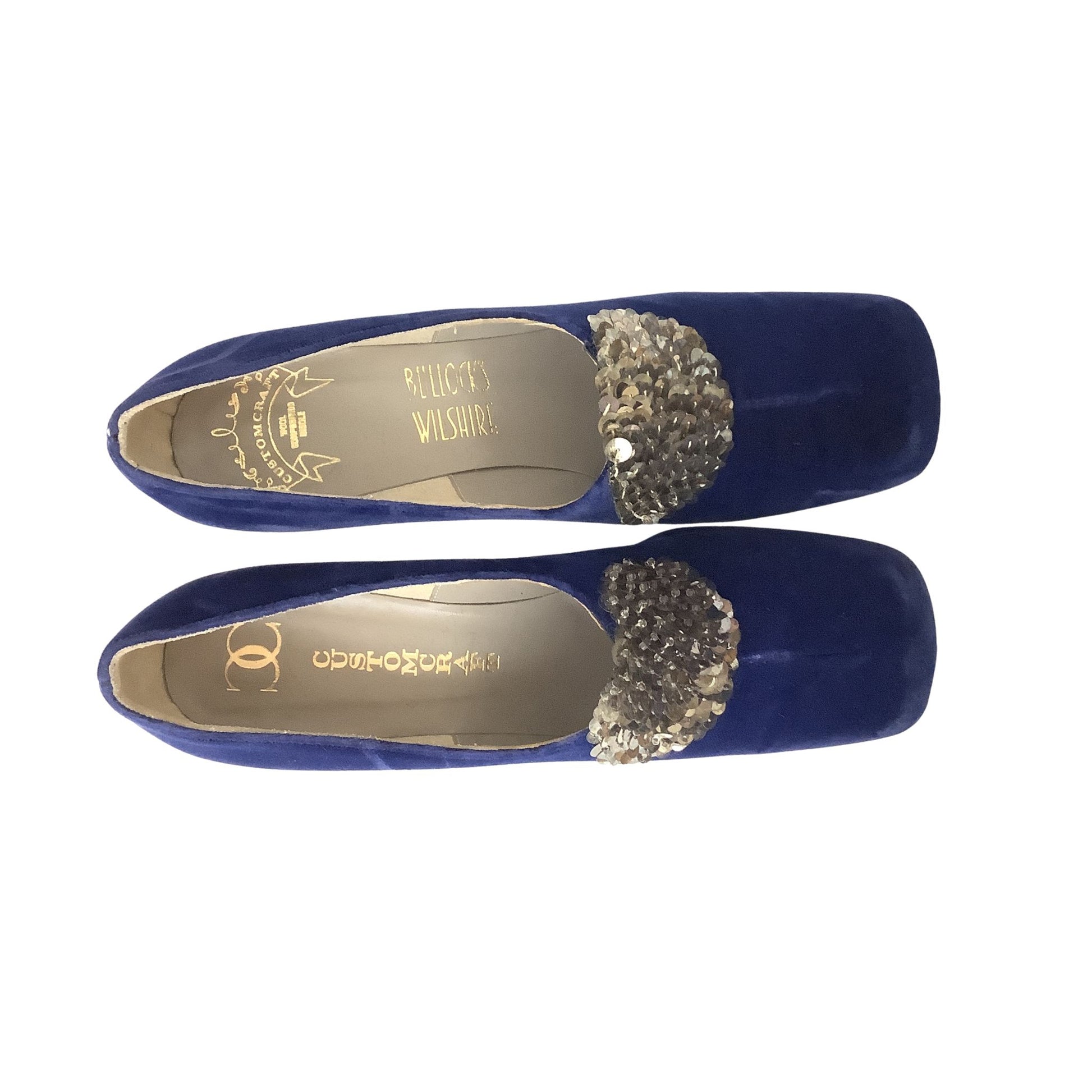 A pair of royal blue velvet Custom Craft heels with a silver sequined decorative accent on the toe, displayed against a solid white background.