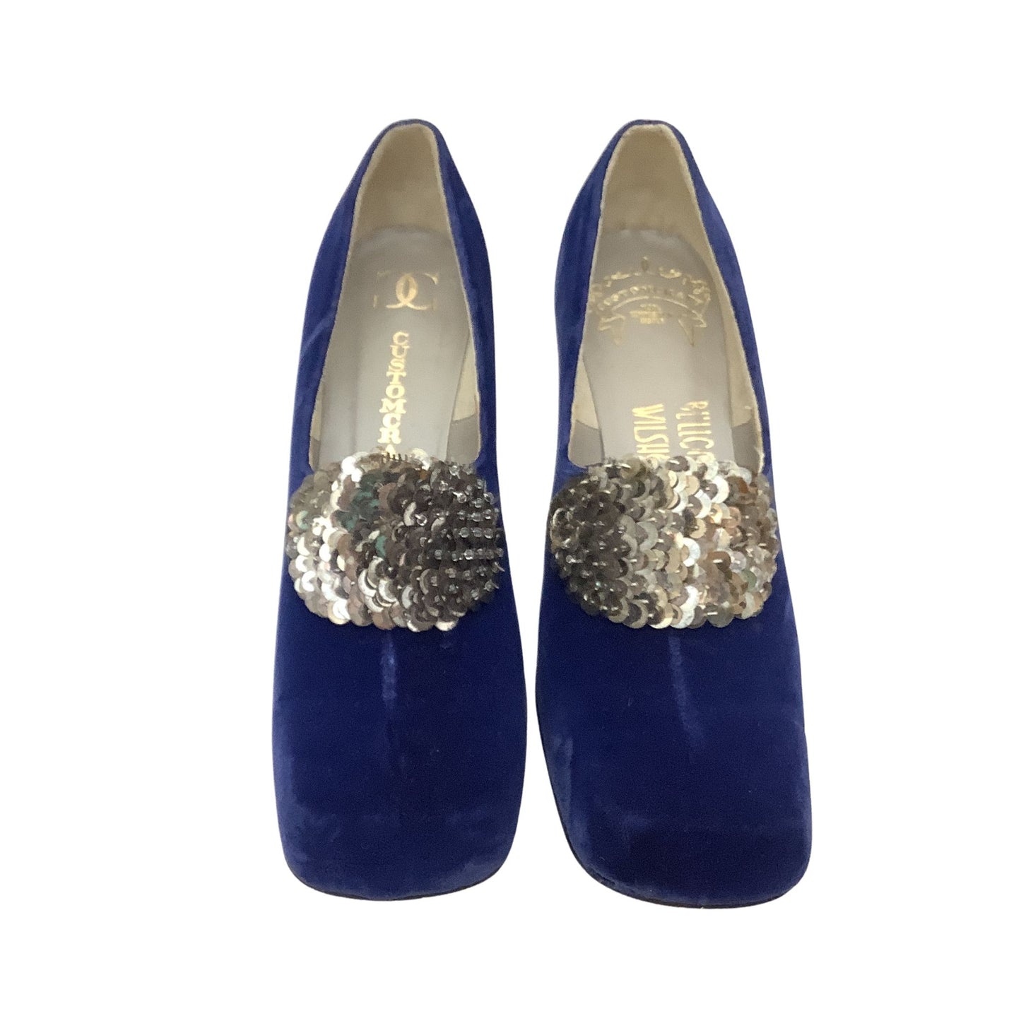 A pair of Custom Craft pumps in royal blue velvet, featuring a prominent silver sequin embellishment across the vamp and logo printed on the insole.