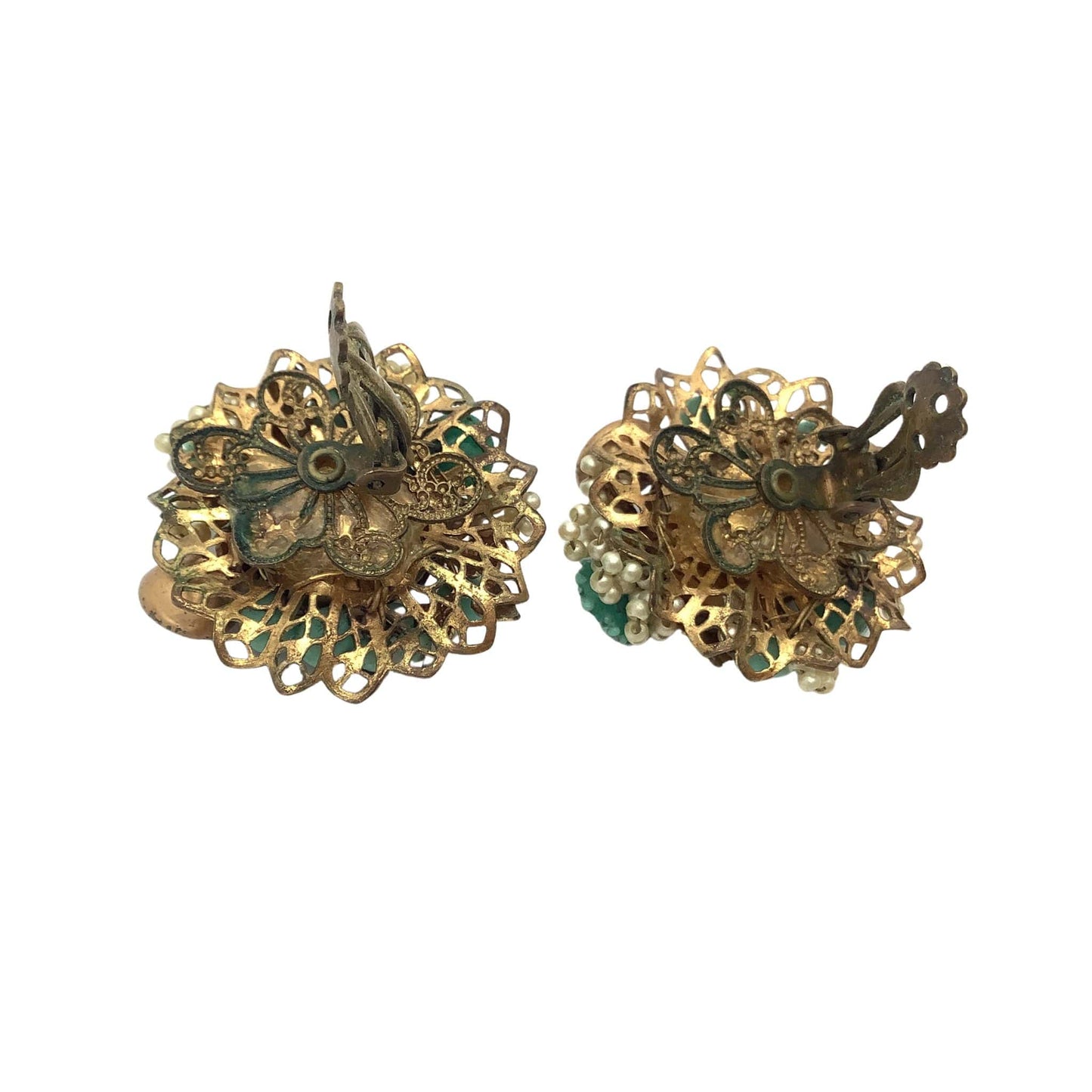 Pair of gold floral earrings on a white background