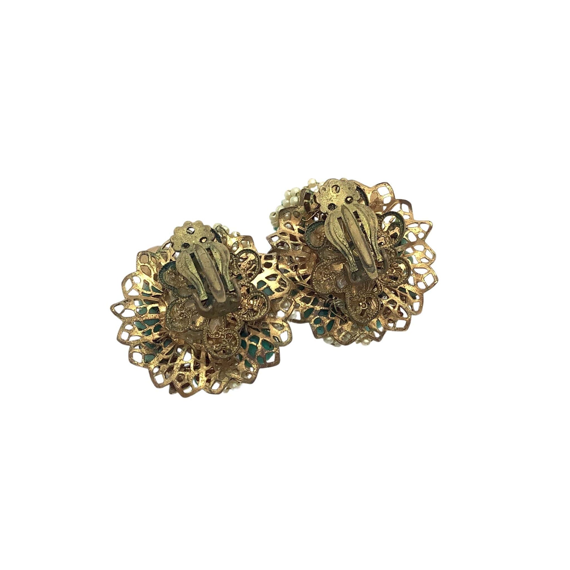 Pair of gold floral earrings on a white background
