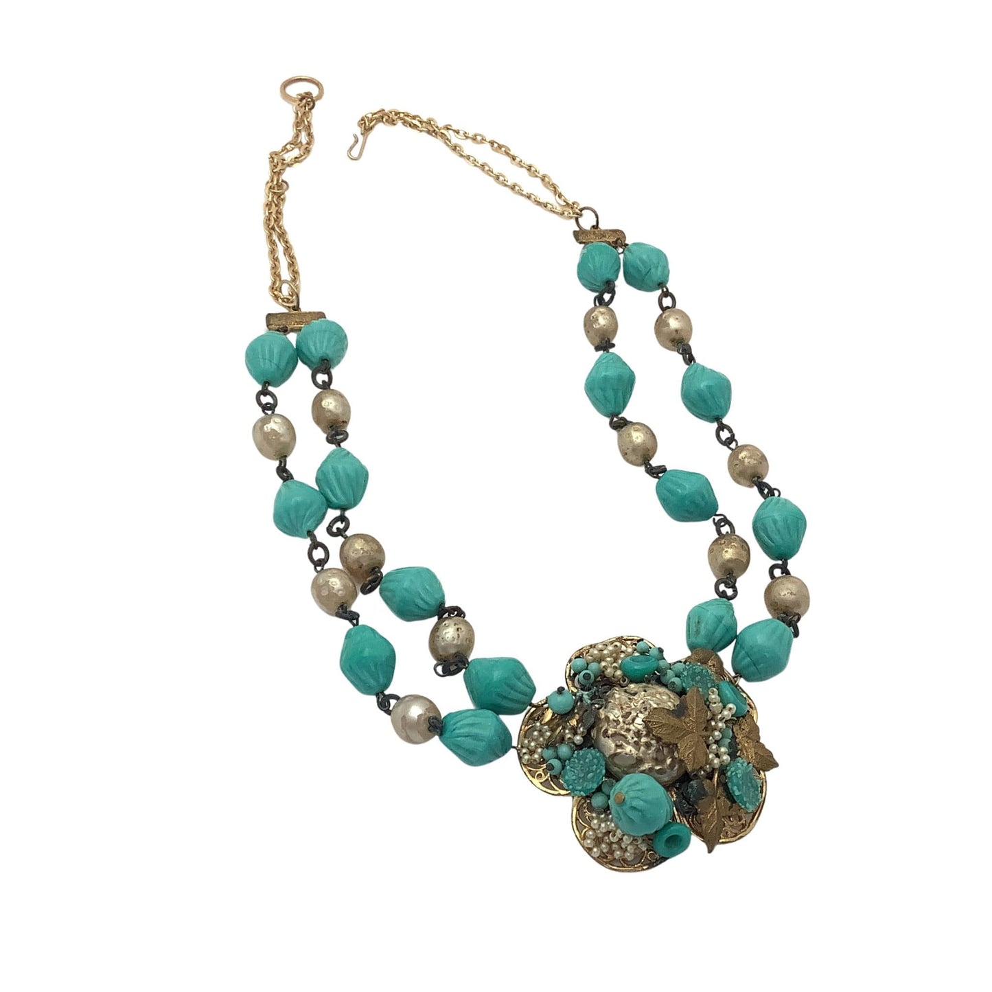 Necklace with turquoise and gold floral design on a white background