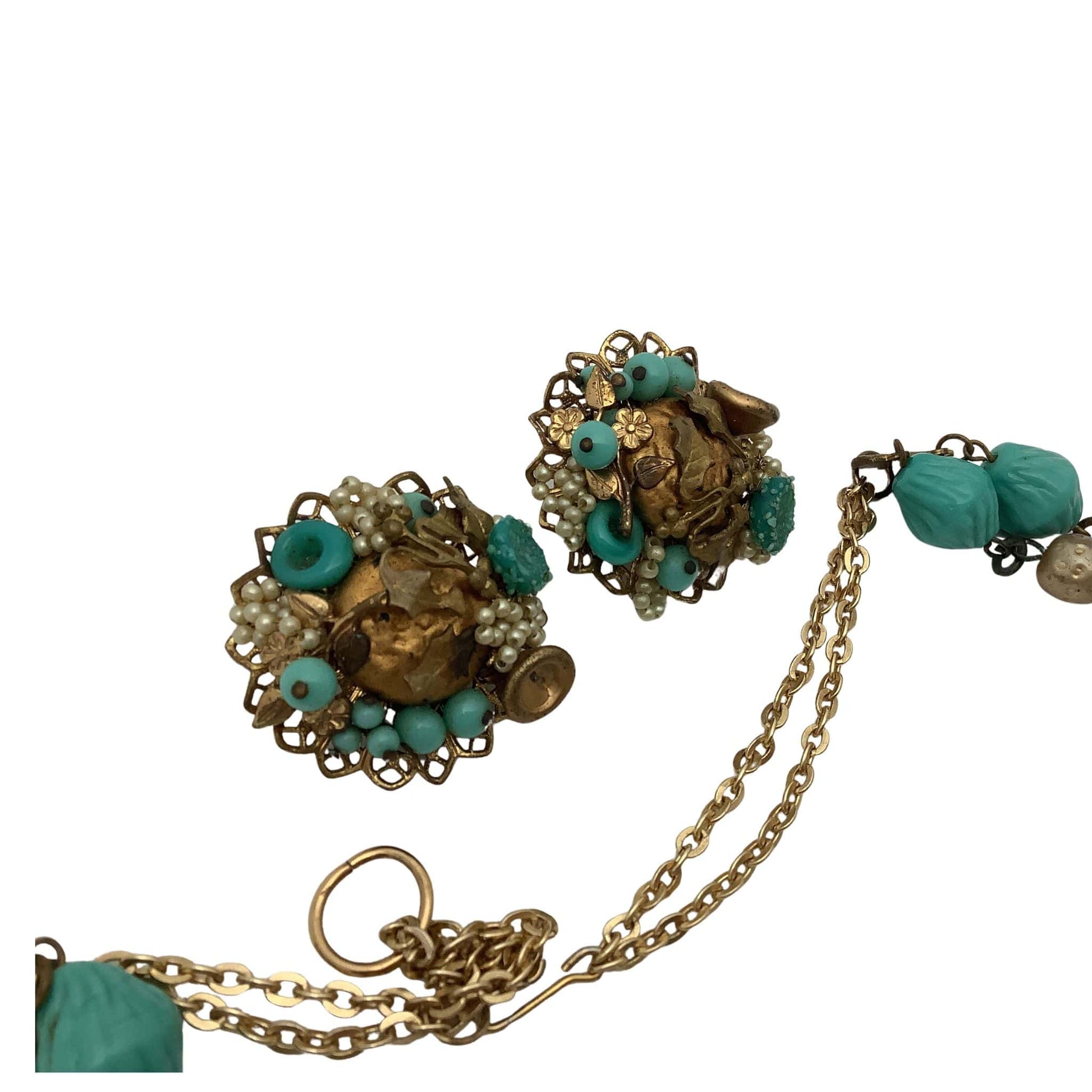 Pair of gold and turquoise beaded earrings on a white background