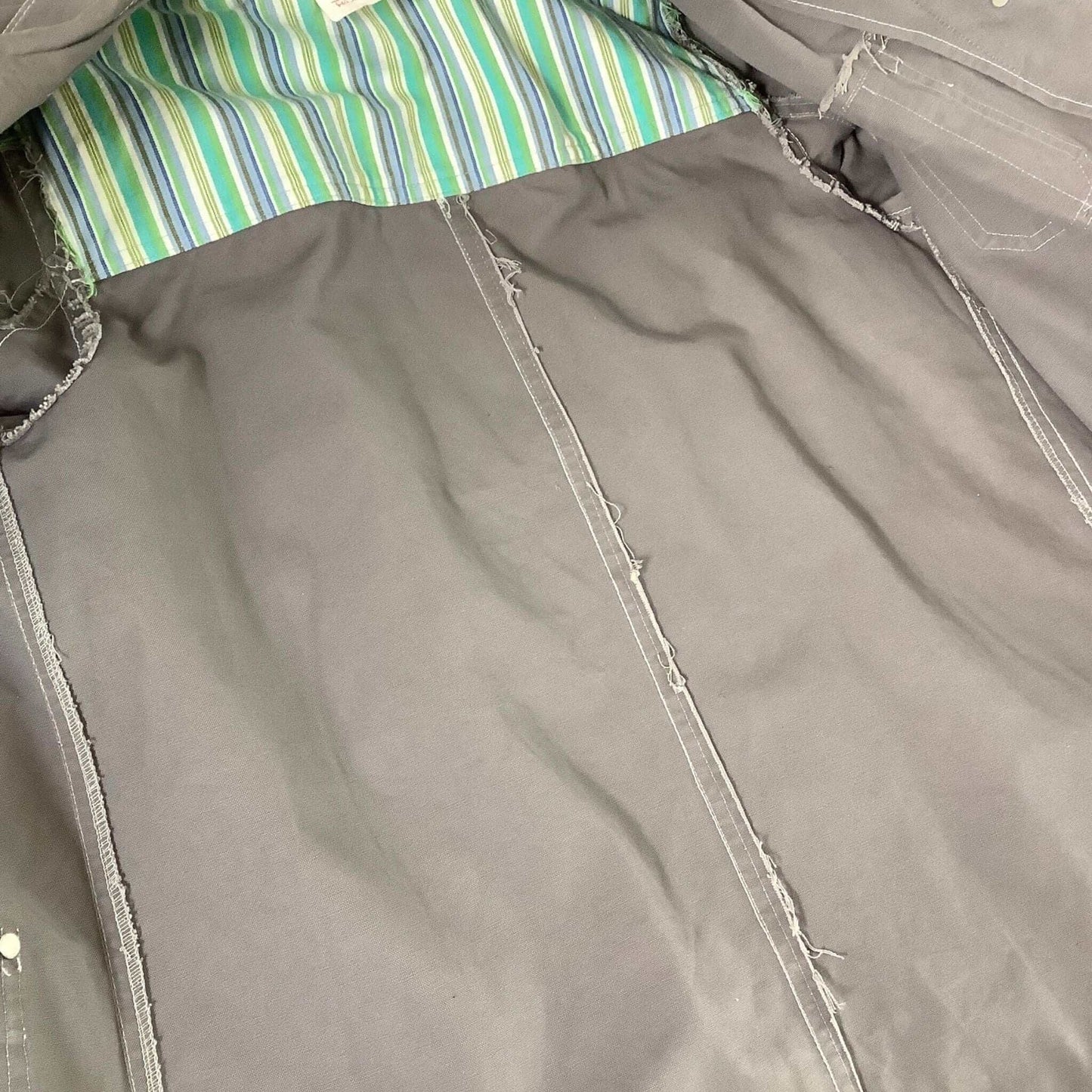 Close-up of a gray fabric surface with stitching details