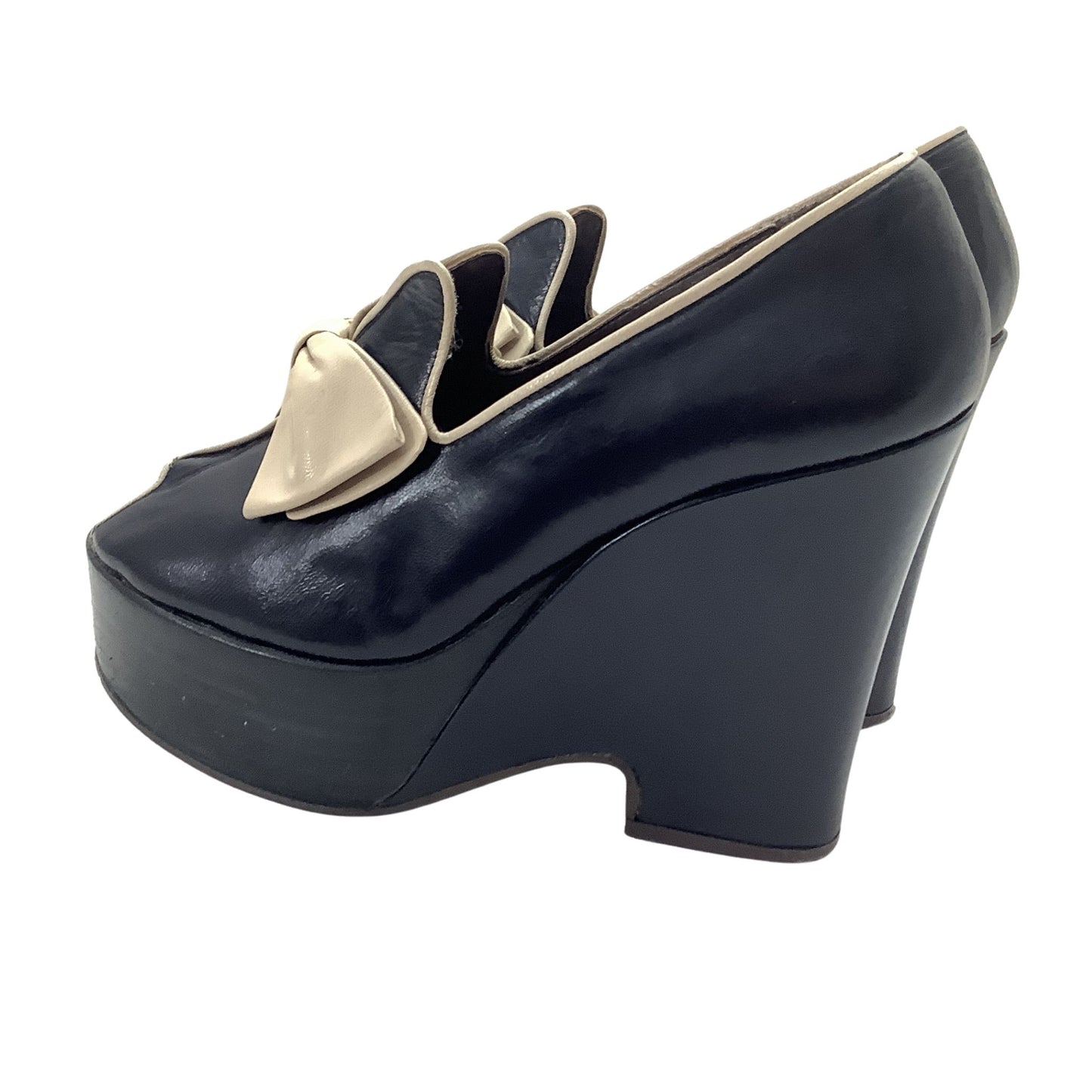 Navy blue leather Elditas platform wedges shoe with  beige bow detail on the vamp, left side view.