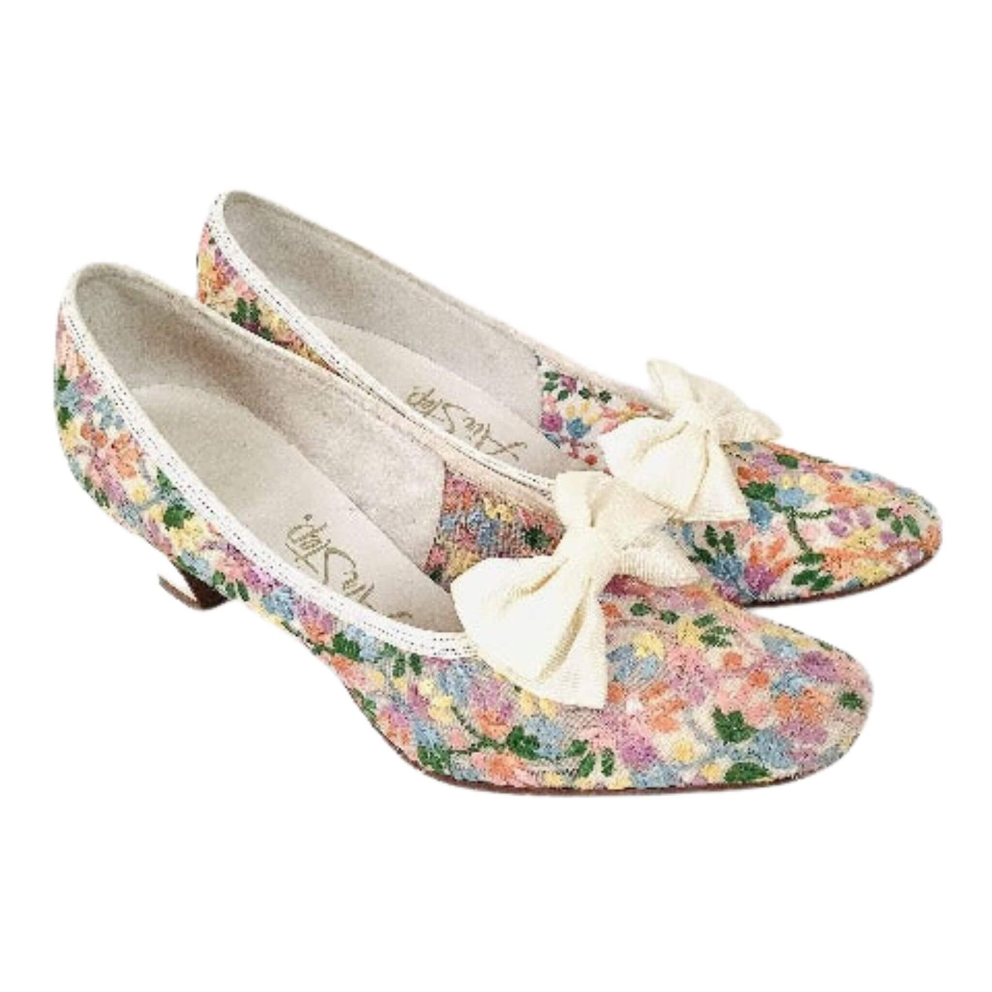 Floral embroidered pumps with white bows top-side view