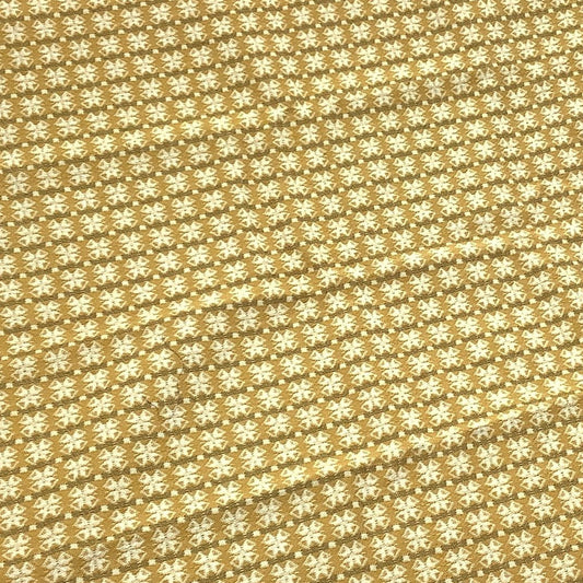 Vintage Schumacher fabric sample in god and beige pattern featuring fringed edges and two small white labels.
