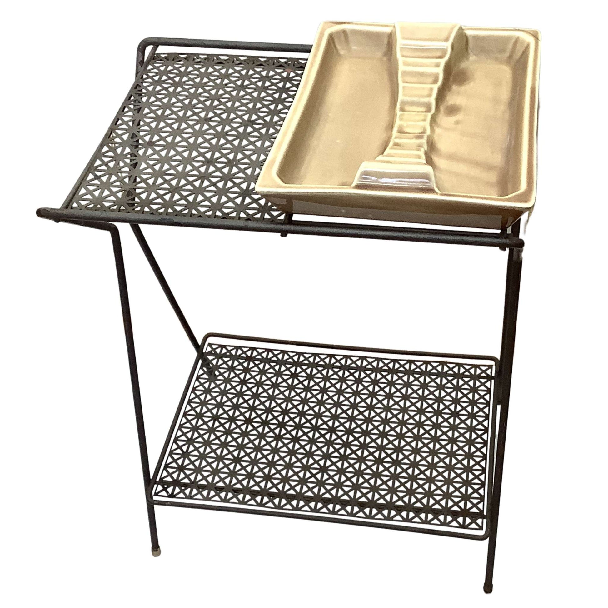 Front view of lower table shelf with a beige ashtray on a white background