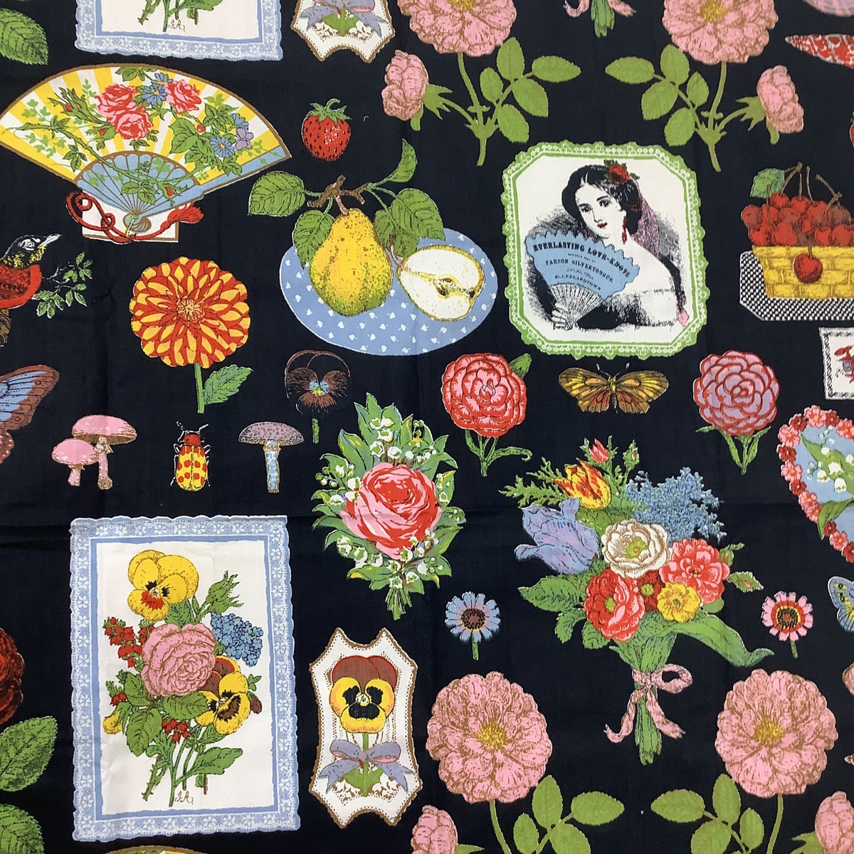 A close-up of a Gloria Vanderbilt fabric printed with a vintage botanical and decorative pattern, featuring pink and red roses, yellow pears, colorful flowers, mushrooms, butterflies, and framed floral illustrations.