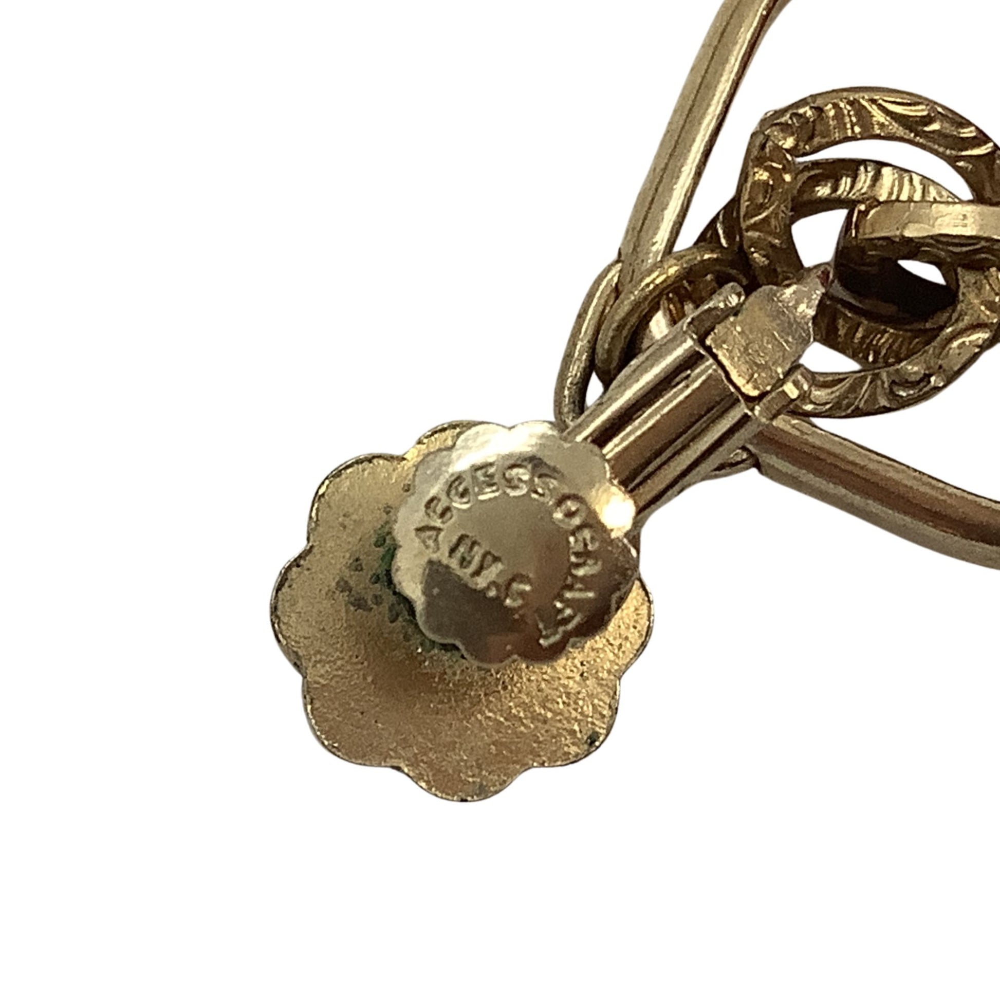 Gold earring with a visible brand logo on a white background