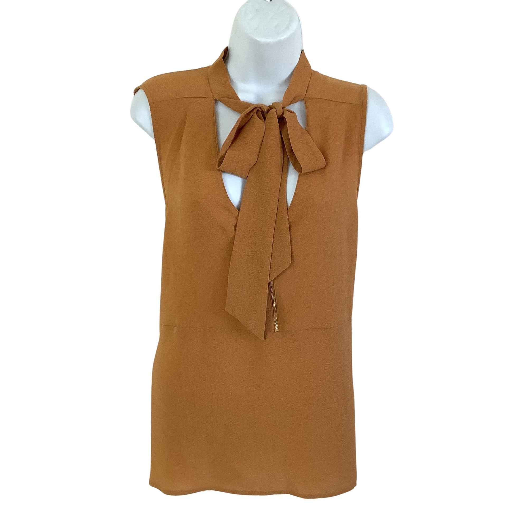 Mustard sleeveless top with a bow tie on a mannequin against a white background