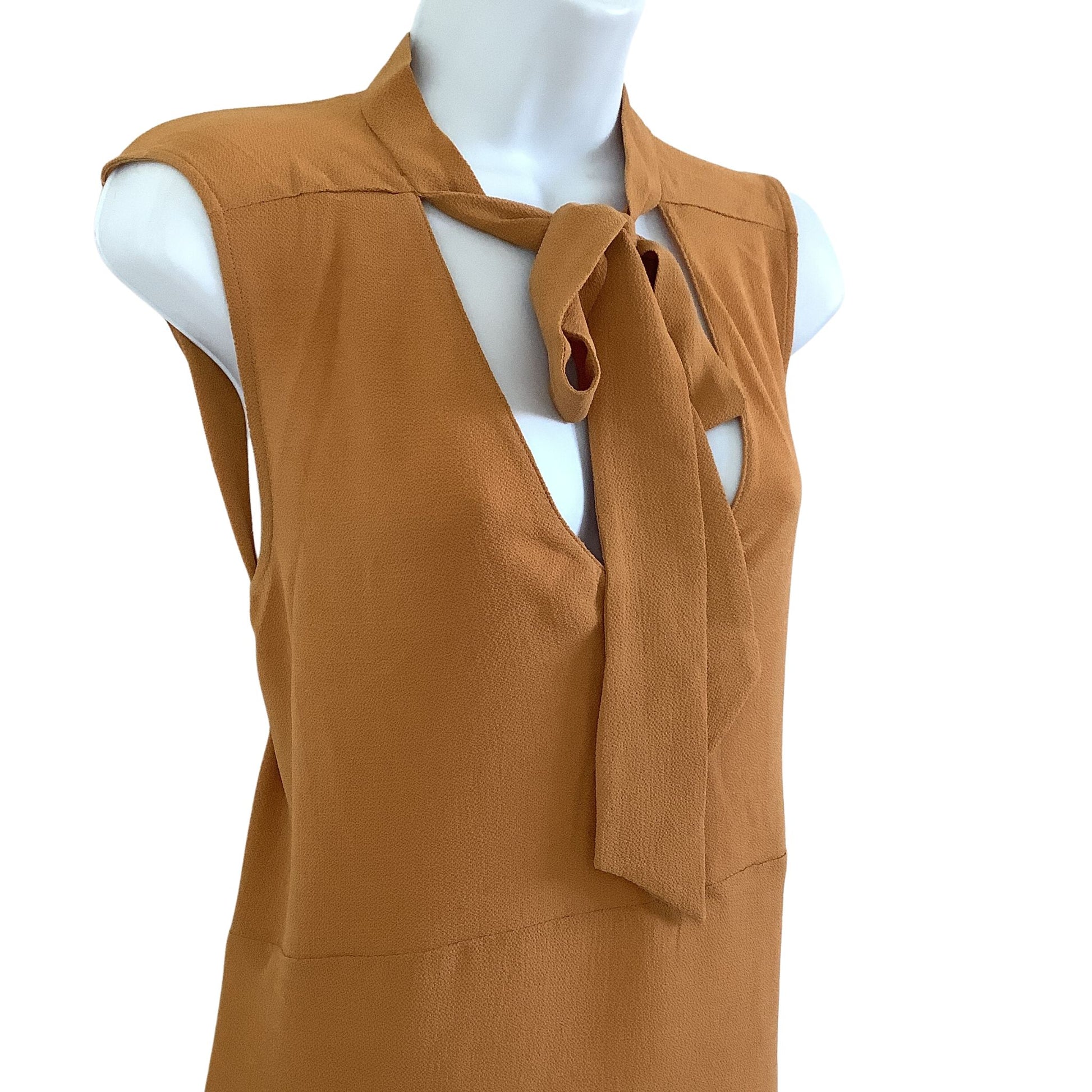Mustard sleeveless top with a tie detail side view on a mannequin against a white background