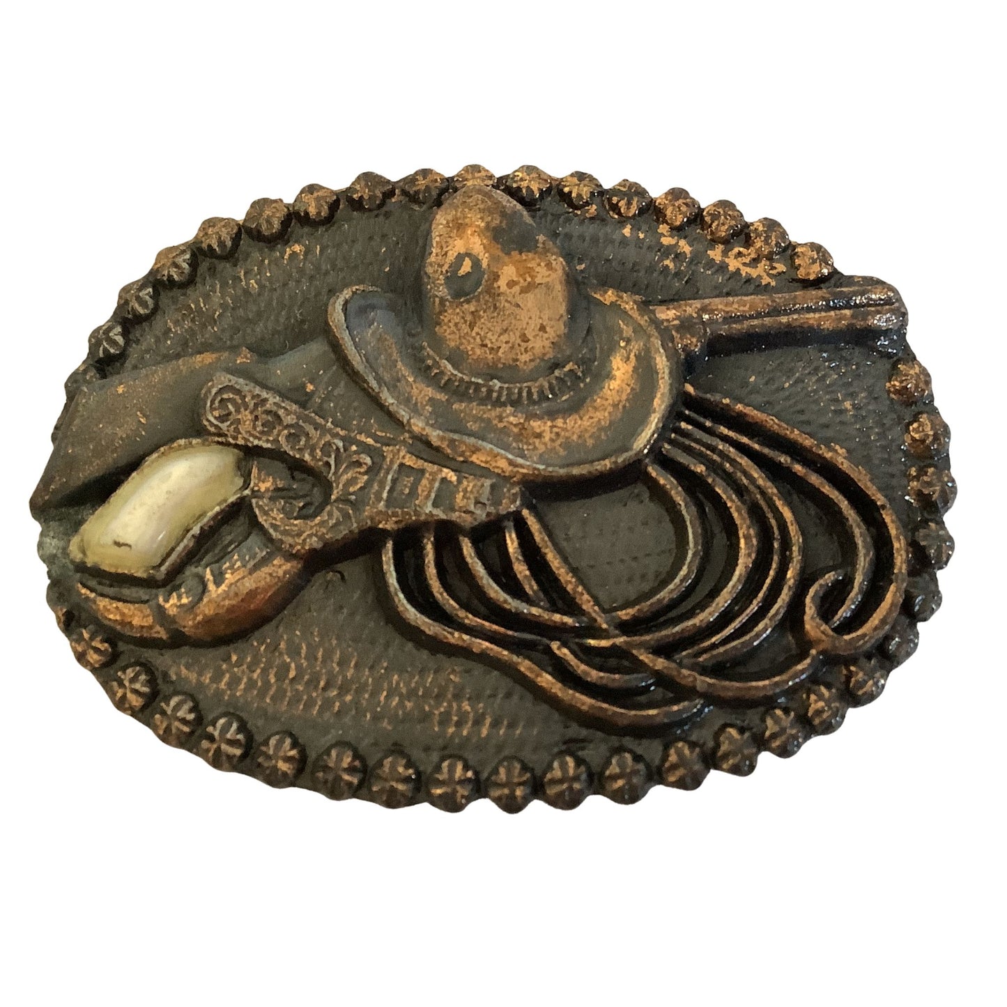 Bronze cowgirl belt buckle with cowboy hat rope and revolver motif on a white background