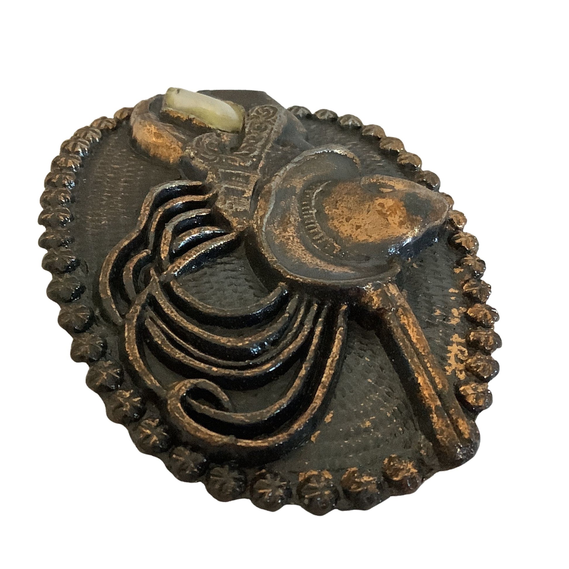 High relief casting detail of western motif belt buckle on a white background