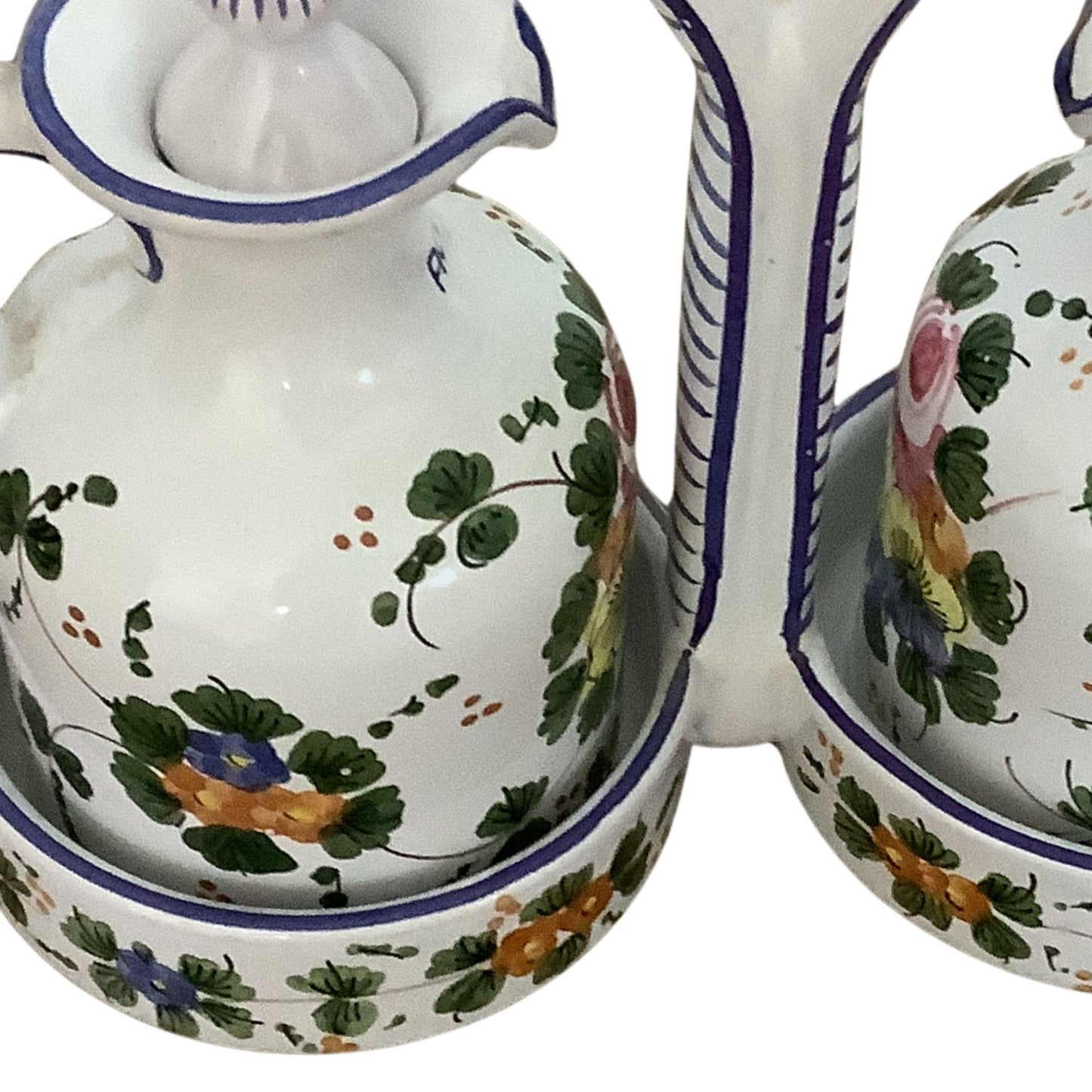 Italian ceramic cruet set with floral patterns detail view on a white background