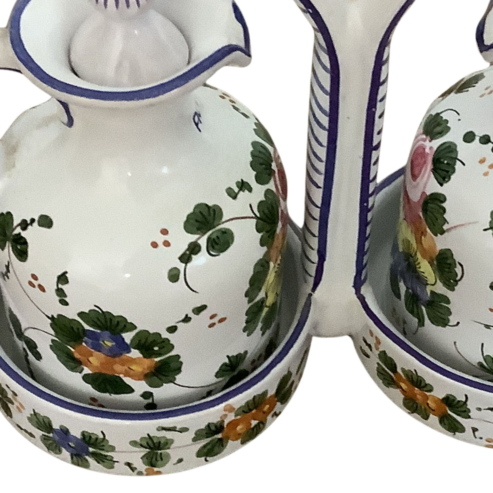 Italian ceramic cruet set with floral patterns detail view on a white background