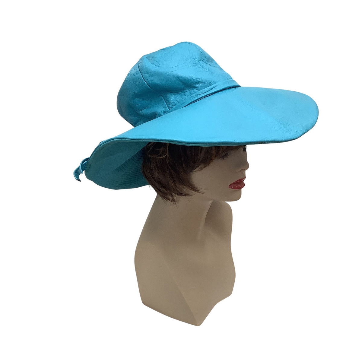 Jacques Heim bright turquoise blue wide-brim leather hat displayed on a female mannequin head against a plain white background.