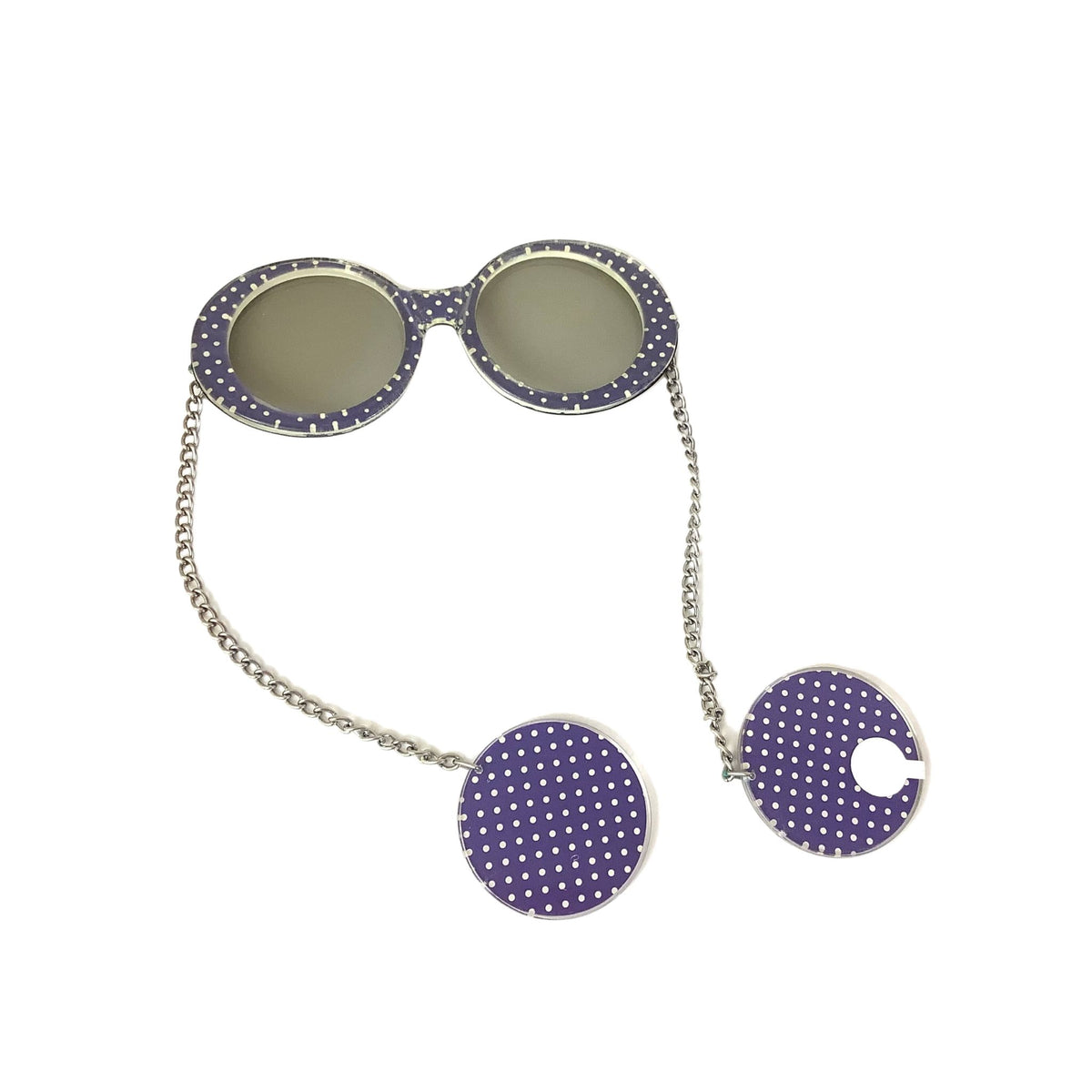 Purple and white polka dot novelty sunglasses with a silver chain and matching round earrings, showing label.
