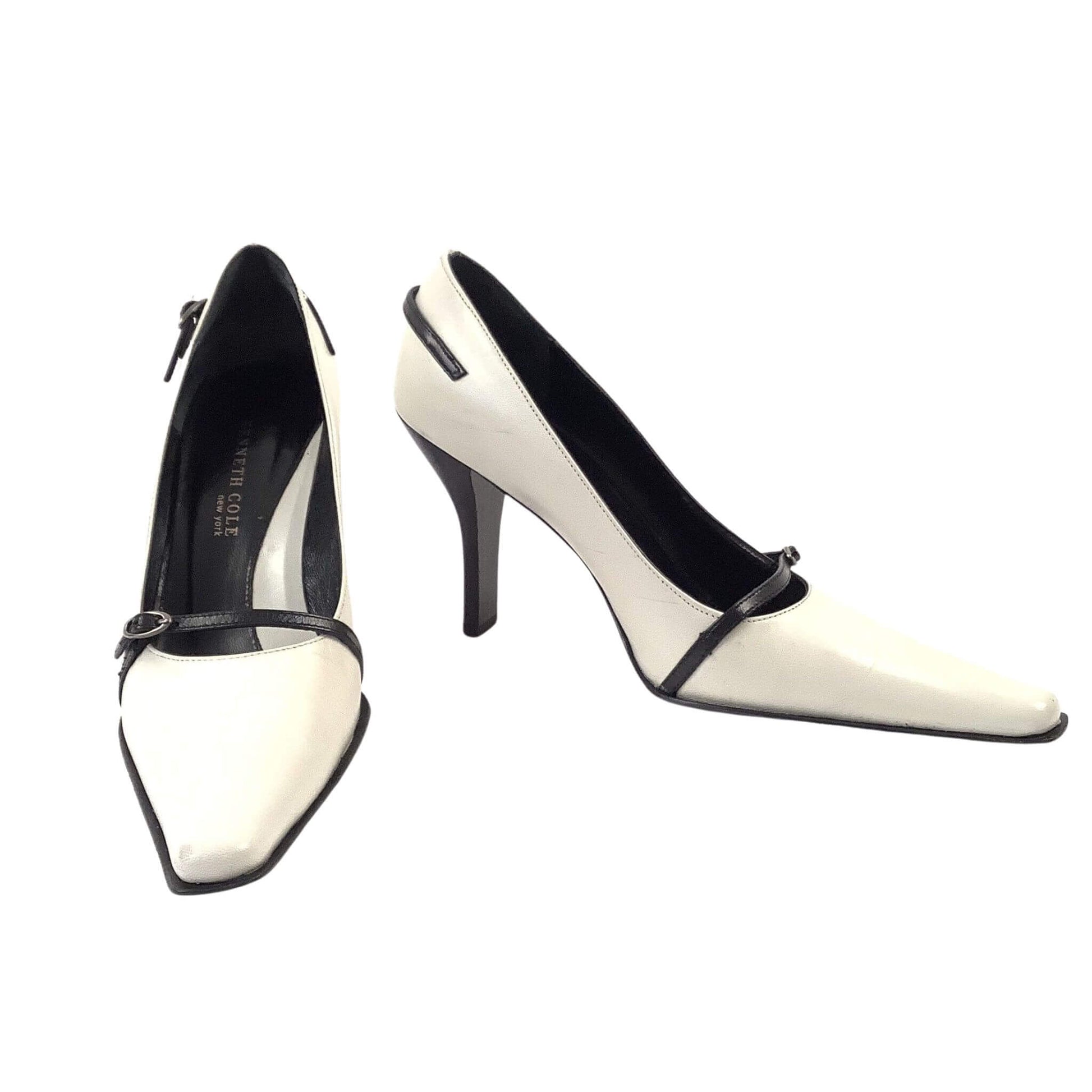 Pair of black and white high-heeled pump shoes front view