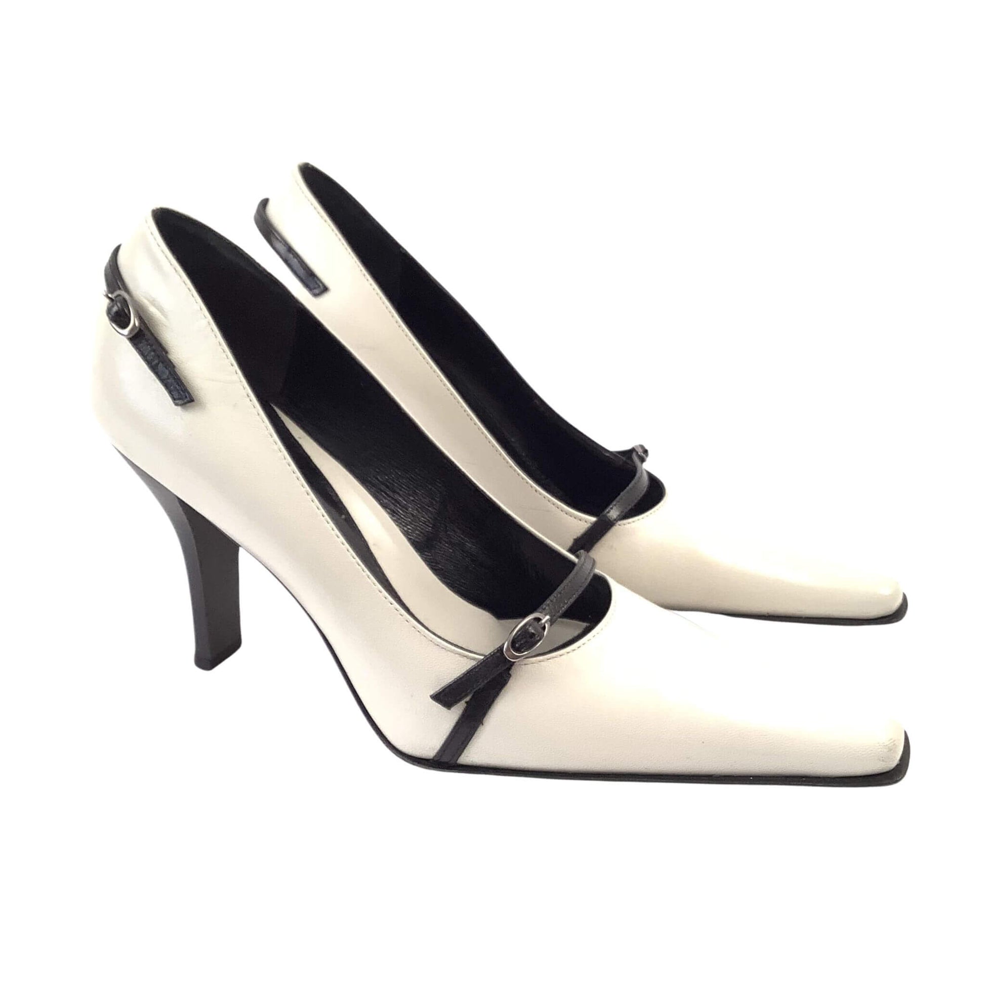Pair of black and white high-heeled shoes left side view